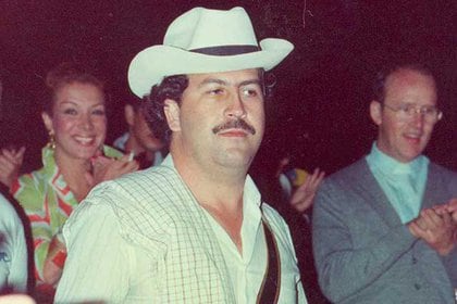 The star Virginia Vallejo smiles behind Pablo Emilio Escobar Gaviria, who was her lover for five years.  Now, he's launched a legal battle against Netflix