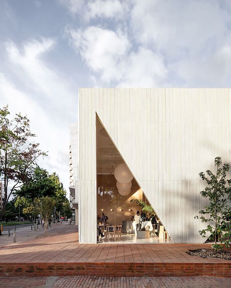 Con base en la ciudad de New York, Studio Cadena diseñó Masa, un nuevo restaurante en un barrio residencial del norte de Bogotá, Colombia. Desde el exterior, las ventanas triangulares y recortadas de la entrada abren la fachada a la calle, para conectarse con la vida de la acera y revelar lo que sucede dentro del restaurante. Lo geométrico y las ventanas, incluyendo la gran ventana circular que mira hacia el jardín desde la cocina, se suman a la calidad lúdica y gráfica del espacio interior (Foto @nkubota )