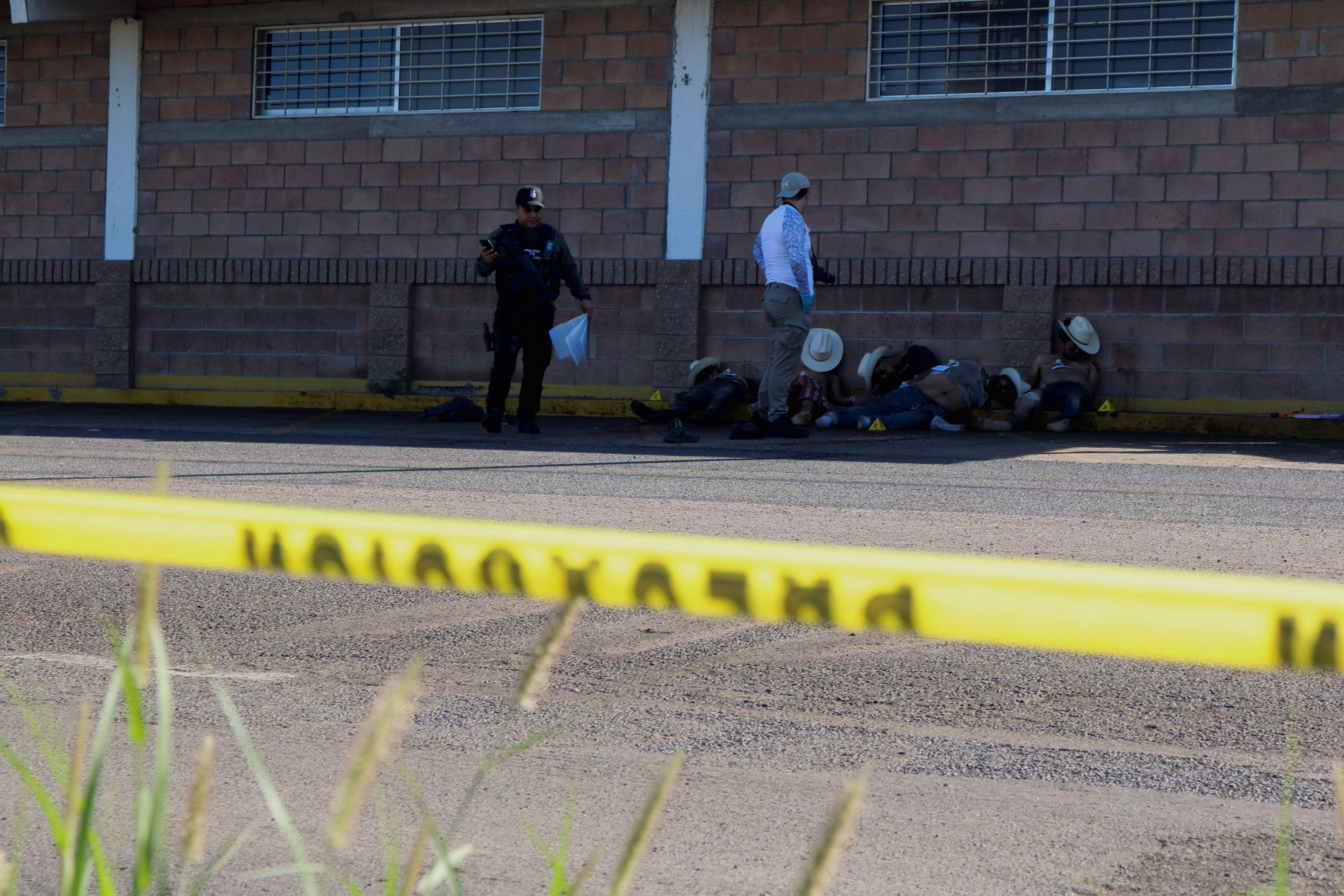 MATERIALES SENSIBLES. ESTA IMAGEN PUEDE OFENSAR O MOLESTAR Un técnico forense trabaja en la escena de un crimen donde cinco hombres fueron asesinados en medio de una ola de violencia entre grupos armados en Culiacán, México, el 15 de septiembre de 2024. REUTERS/Jesús Bustamante