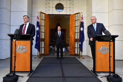 El Secretario del Departamento de Salud de Australia, Dr. Brendan Murphy, el Ministro de Salud Greg Hunt y el Primer Ministro Scott Morrison asisten a una conferencia de prensa en la Casa del Parlamento en Canberra, Australia, el 11 de diciembre de 2020. Imagen AAP / Mick Tsikas / vía REUTERS