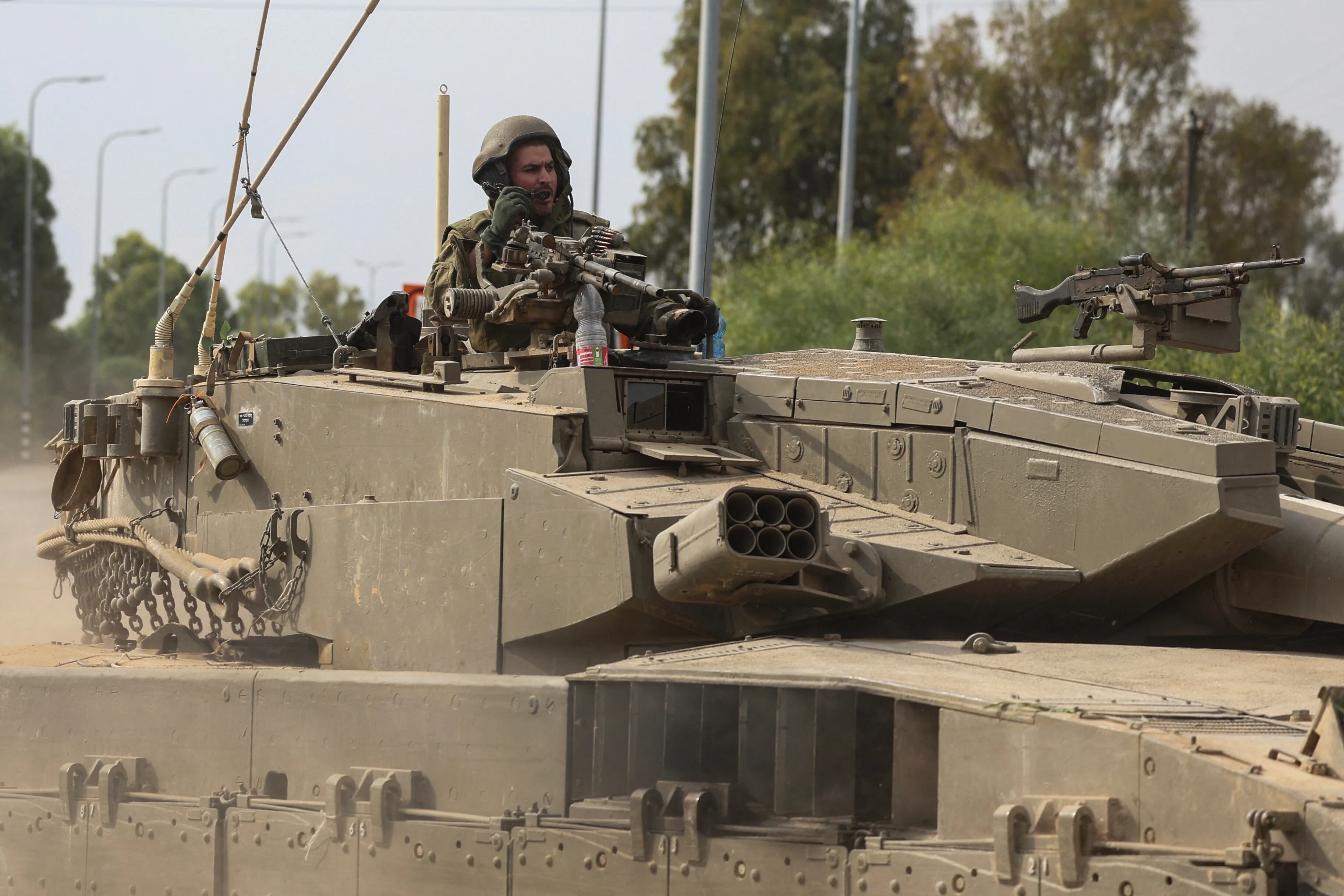 Israeli soldiers drive in a tank by Israel's border with Gaza in southern Israel, October 10, 2023. REUTERS/Ronen Zvulun