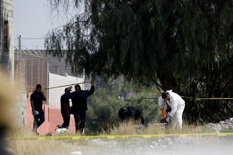 Forensic experts are seen at the crime scene of Karol Nahomi, a baby girl who according to local media was kidnapped and found dead, in Saltillo, Mexico February 19, 2020. REUTERS/Daniel Becerril