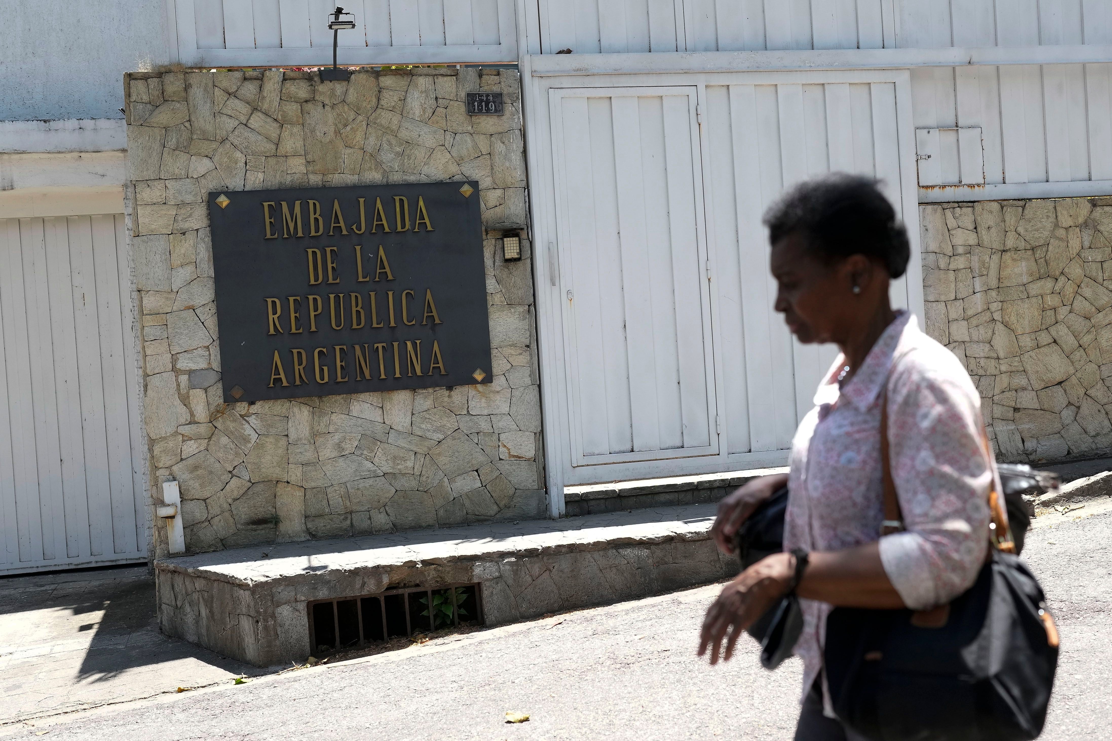 Una mujer pasa por la residencia del embajador de Argentina en Caracas, Venezuela 