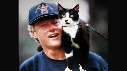 El ex presidente Bill Clinton con Socks en su hombro