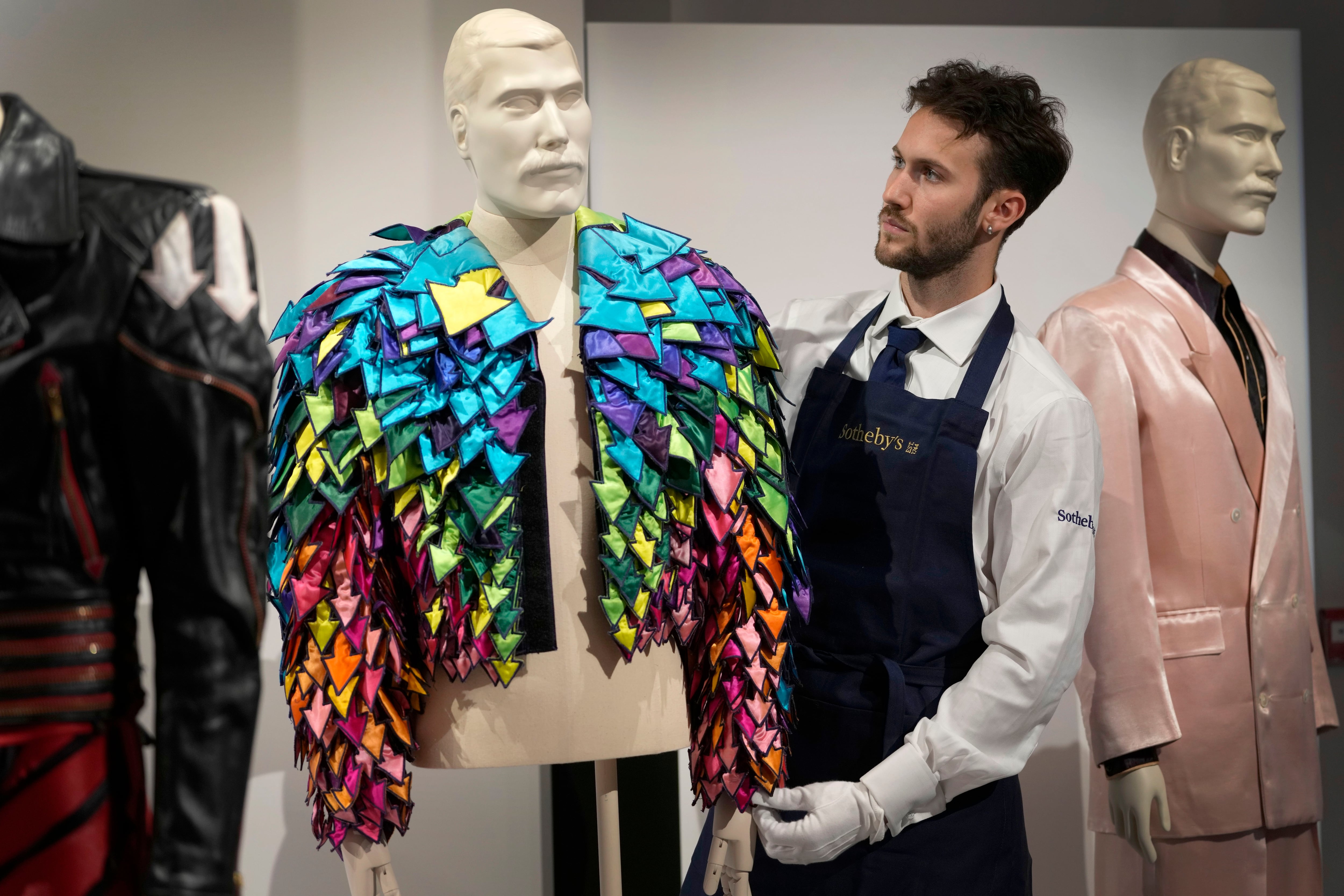 Un empleado de Sotheby's muestra una chaqueta con apliques de flechas de satén de color arcoiris de 1982 en las salas de la casa de subastas de Sotheby's en Londres (AP/Kirsty Wigglesworth)