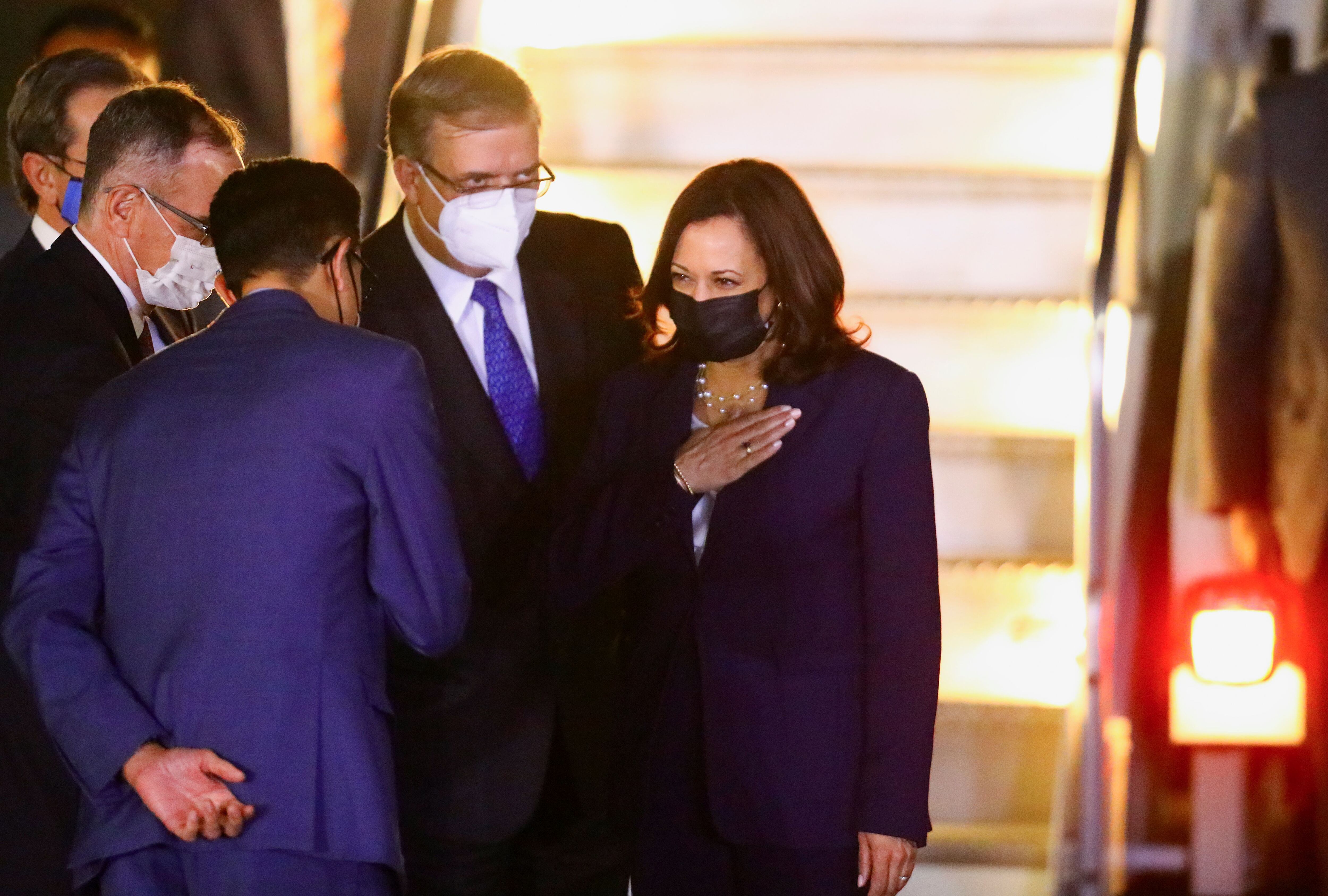 U.S. Vice President Kamala Harris is greeted by Mexican Foreign Minister Marcelo Ebrard as she steps off the plane upon arrival at Benito Juarez International airport in Mexico City, for her first international trip as Vice President to Guatemala and Mexico, in Mexico June 7, 2021. REUTERS/Edgard Garrido