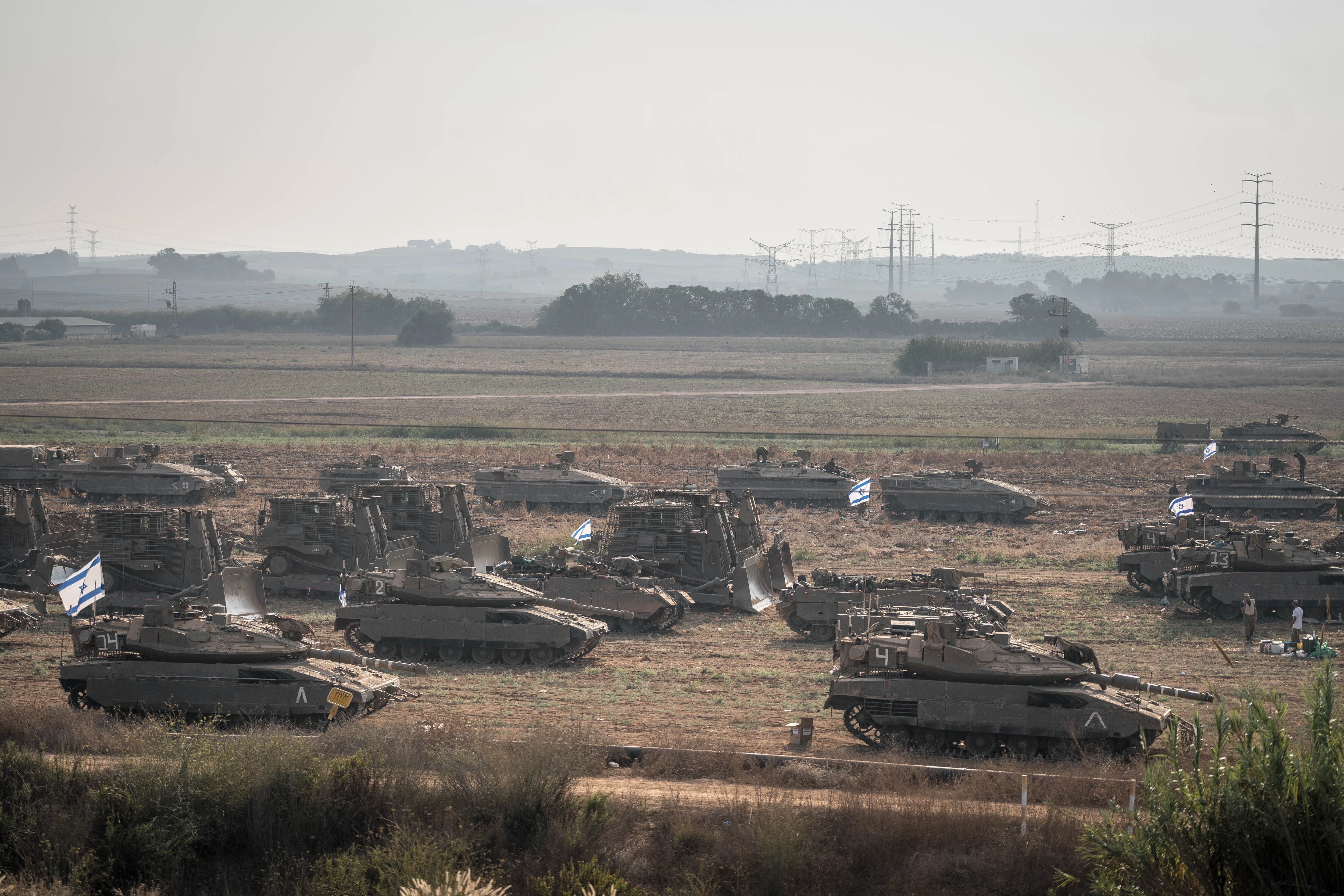 Israeli tanks massed outside Erez, near the border with the Gaza Strip on Saturday, Ot. 14, 2023. Amid signs that Israel was preparing for a ground invasion, displaced Palestinians struggled to find food or places to shelter as the U.N. warned that clean water in Gaza was running out. (Sergey Ponomarev/The New York Times)