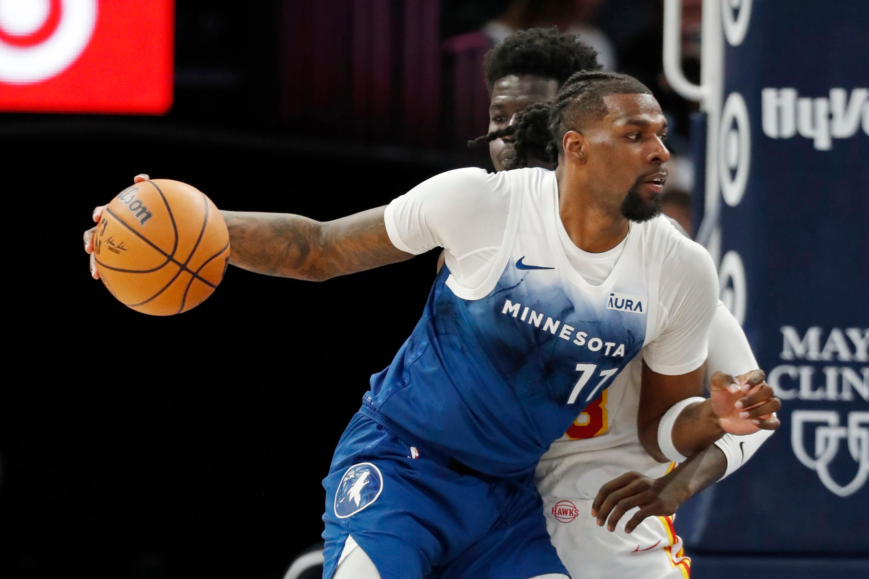 Naz Reid, pívot de los Timberwolves de Minnesota, elude a Mouhamed Gueye, de los Hawks de Atlanta, en el partido del viernes 12 de abril de 2024 (AP Foto/Bruce Kluckhohn)