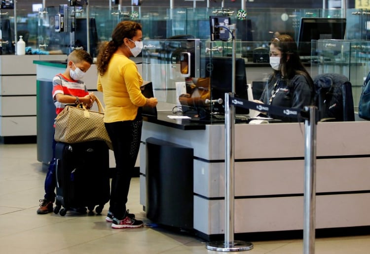 Foto de archivo. Pasajeros hacen trámites de inmigración usando tapabocas para evitar el contagio con coronavirus en el aeropuerto Intrenacional El Dorado de Bogotá, Colombia, 5 de marzo, 2020. REUTERS/ Leonardo Muñoz. NO VENTA NO ARCHIVO