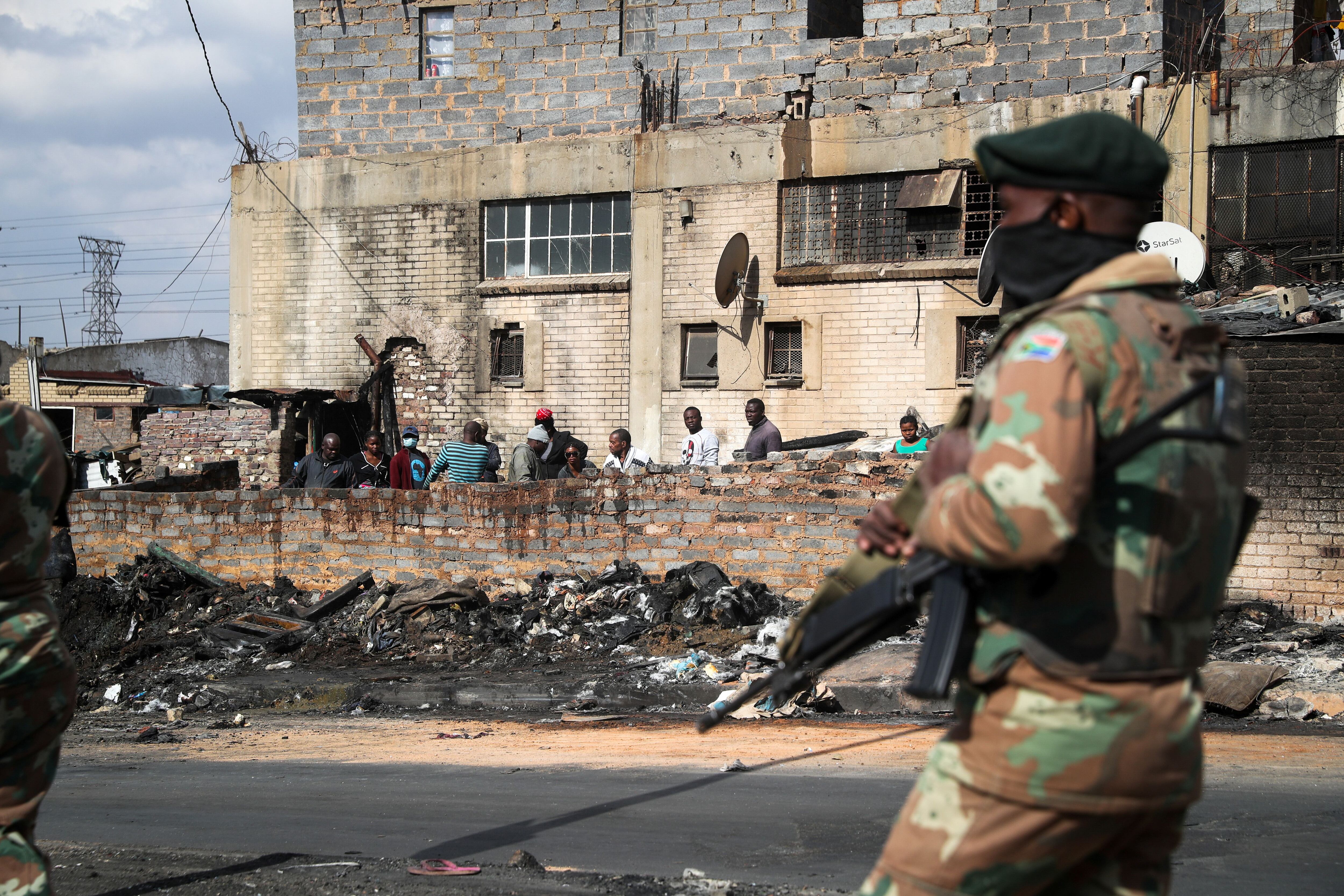 Members of the military patrol through the streets of Alexandra township as the country deploys the army to quell unrest linked to the jailing of former President Jacob Zuma, in Johannesburg, South Africa, July 15, 2021. REUTERS/Sumaya Hisham