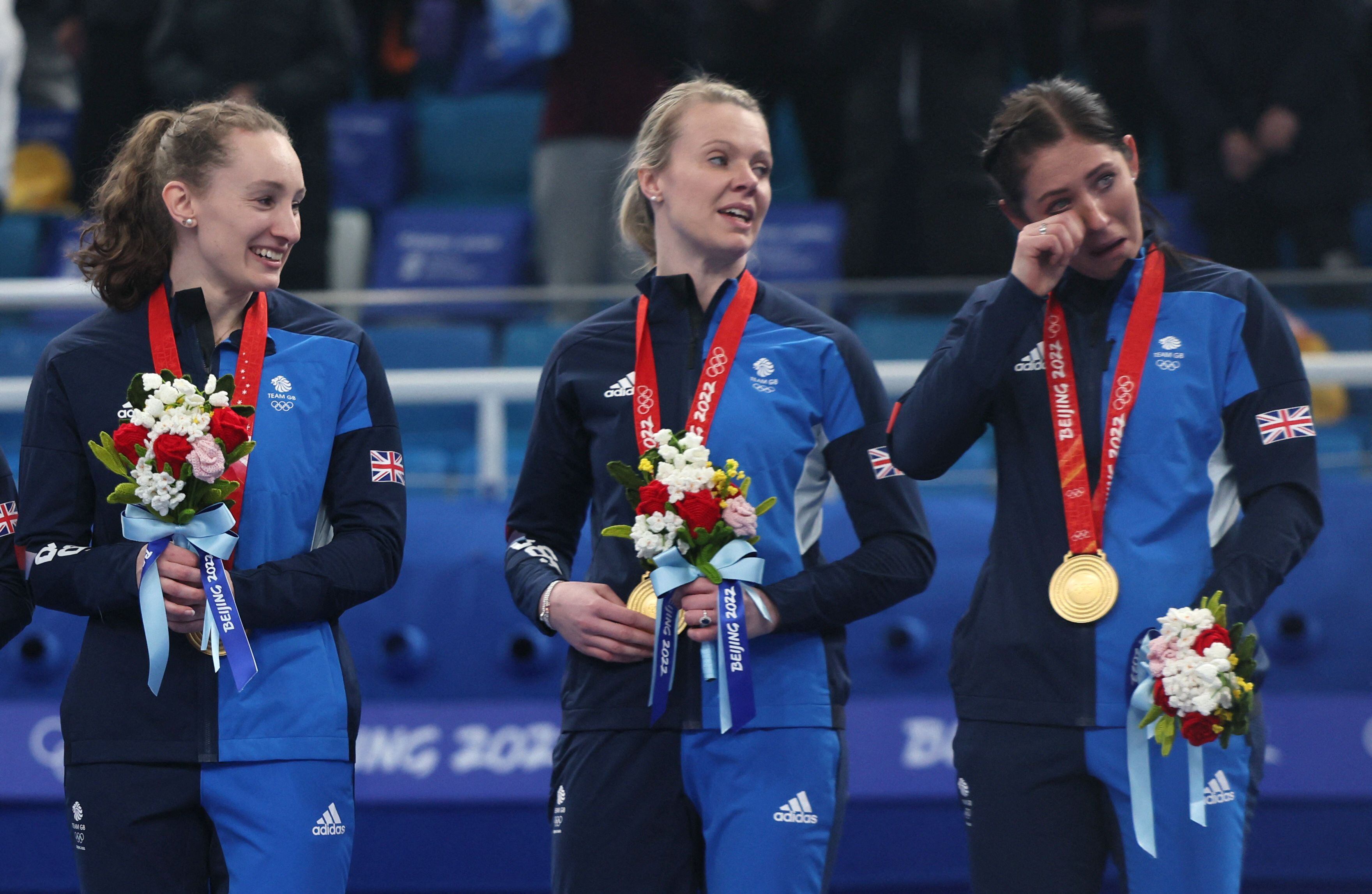 2022 Beijing Olympics - Victory Ceremony - Curling -Women's Gold Medal - National Aquatics Center, Beijing, China - February 20, 2022. Gold medallists Jennifer Dodds of Britain, Vice Vicky Wright of Britain and Skip Eve Muirhead of Britain react on the podium. REUTERS/Evelyn Hockstein