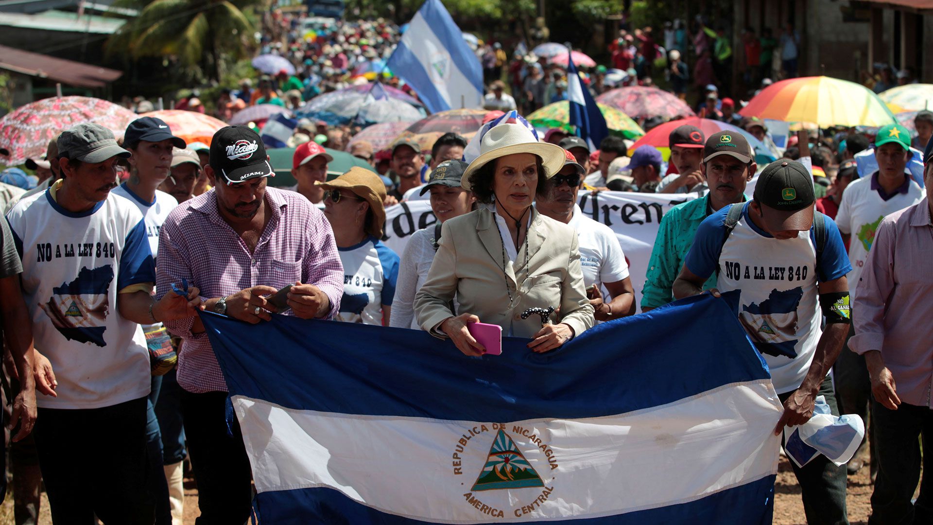 Human rights activist Bianca Jagger holds a Nicaragua's flag during a march to protest against the construction of Interoceanic canal at La Fonseca