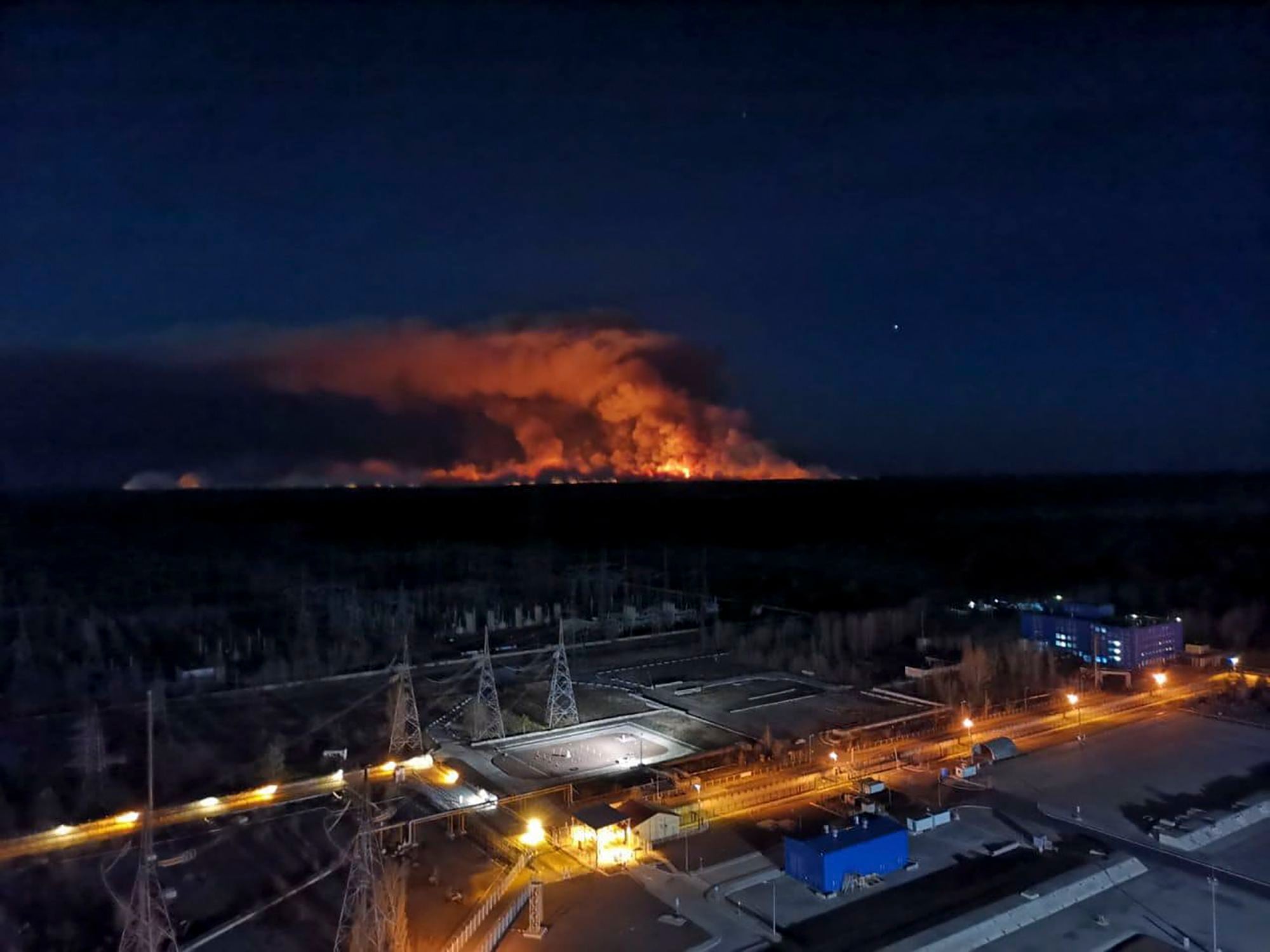 This image taken from the roof of the Chernobyl nuclear power plant, in Ukraine, on Friday, April 10, 2020, shows a wildfire near the plant in the exclusion zone. (Press Office of the Ukrainian Police via AP)