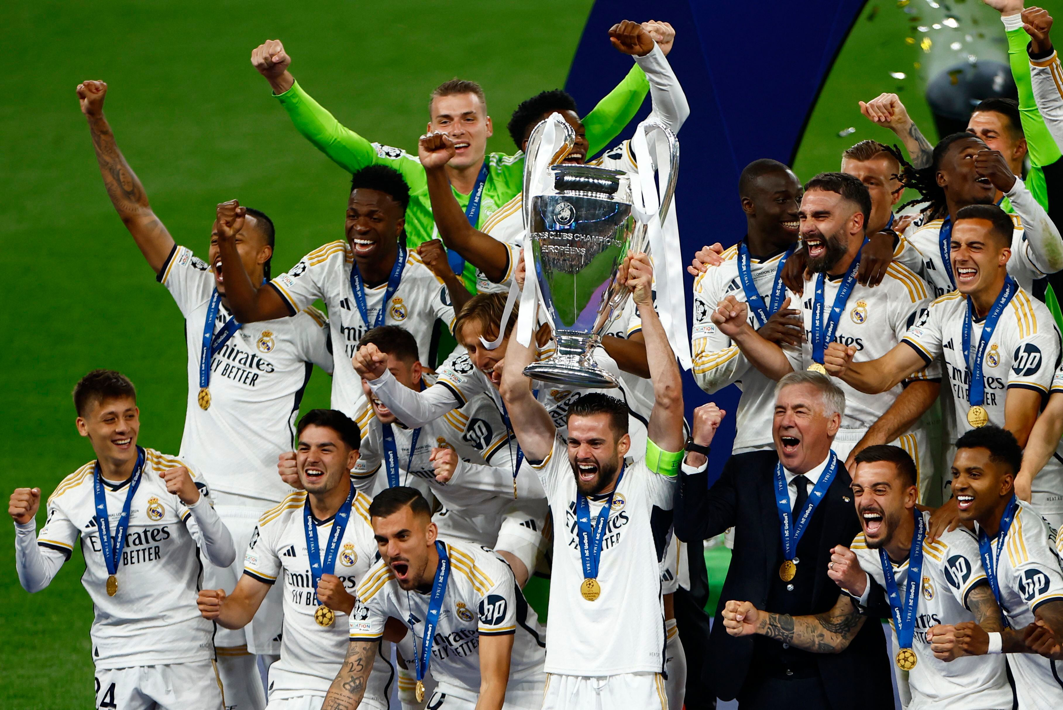 Soccer Football - Champions League - Final - Borussia Dortmund v Real Madrid - Wembley Stadium, London, Britain - June 1, 2024 Real Madrid's Nacho lifts the trophy as he celebrates with teammates after winning the Champions League REUTERS/Sarah Meyssonnier