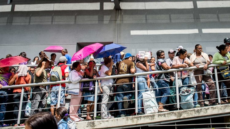Las largas filas para proveerse de alimentos o bienes de consumo básicos son cosa de todos los días en Venezuela. Foto: AFP.