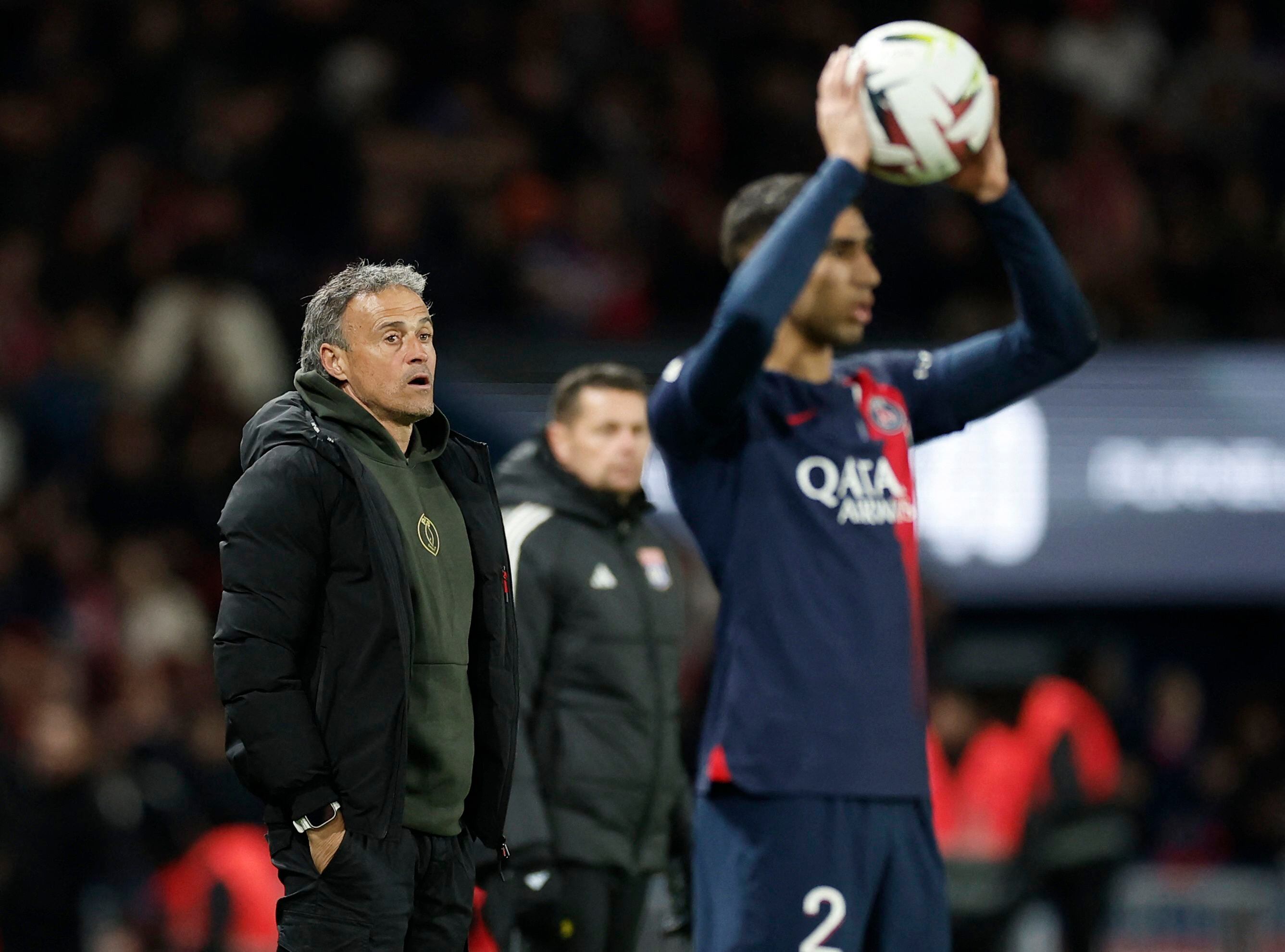 Soccer Football - Ligue 1 - Paris St Germain v Olympique Lyonnais - Parc des Princes, Paris, France - April 21, 2024 Paris St Germain's Achraf Hakimi in action as coach Luis Enrique looks on REUTERS/Benoit Tessier