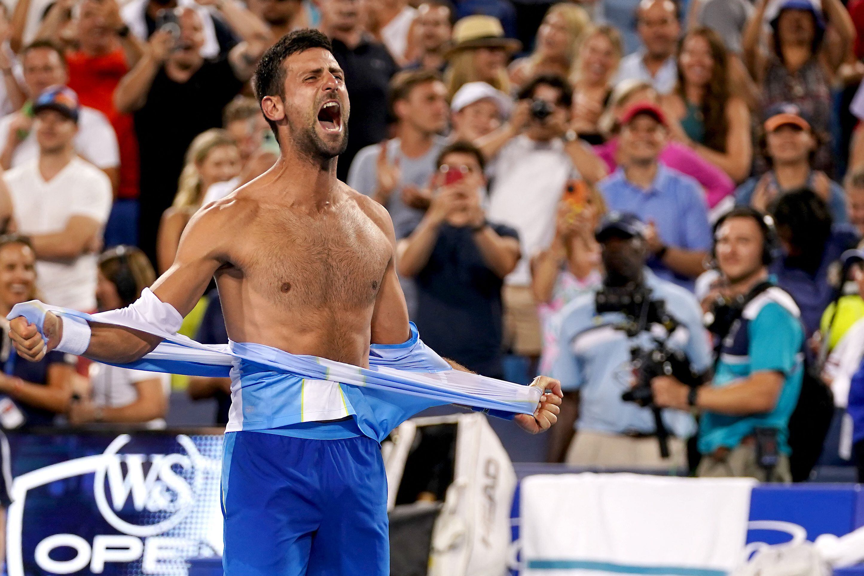 Aug 20, 2023; Mason, OH, USA; Novak Djokovic, of Serbia, rips his shirt in celebration after defeating Carlos Alcaraz, of Spain, at the conclusion of the menÕs singles final of the Western & Southern Open tennis tournament at Lindner Family Tennis Center. Mandatory Credit: Kareem Elgazzar/The Enquirer-USA TODAY Sports