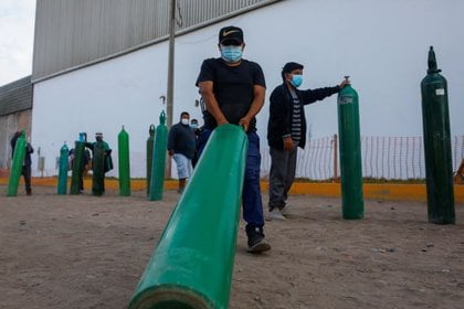 Las filas para recargar los tanques de oxígeno, un elemento escaso para el tratamiento de pacientes (Reuters)