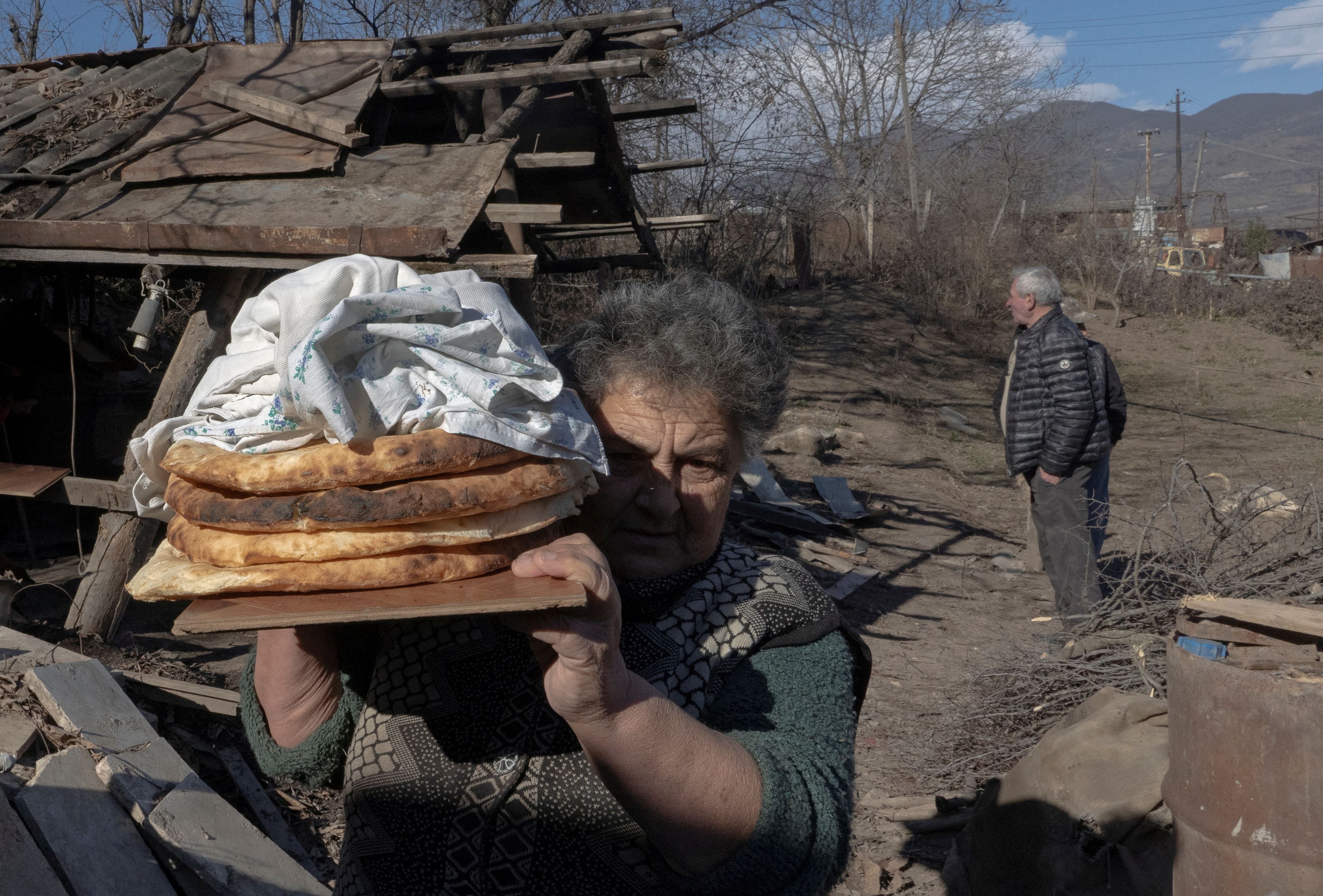 Una foto de 2021 donde un residente local transporta pan fresco en la localidad disputada de Taghavard, en la región de Nagorno Karabaj (REUTERS/Artem Mikryukov)