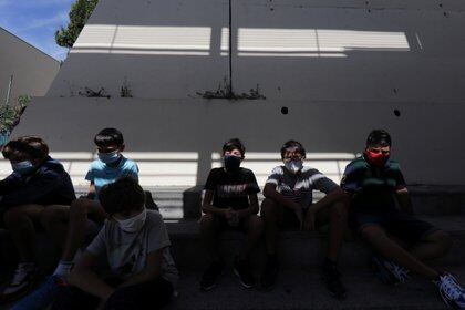 Estudiantes con máscaras protectoras se sientan en el patio del Henri Matisse College (REUTERS / Eric Gaillard)