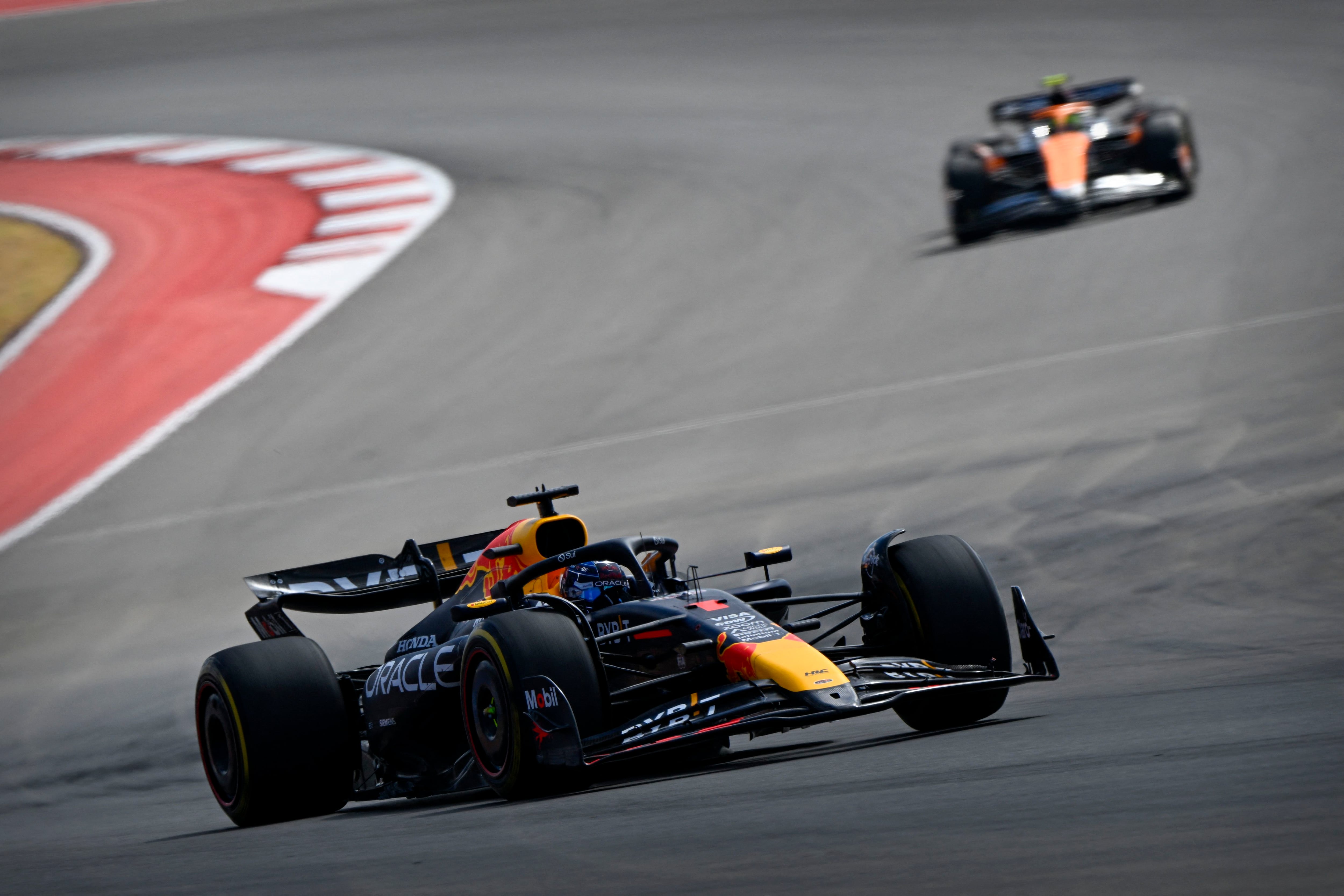 Oct 19, 2024; Austin, Texas, USA; Oracle Red Bull Racing driver Max Verstappen (1) of Team Netherlands leads McLaren Formula 1 Team driver Lando Norris (4) of Team Great Britain during the Sprint Race in the 2024 Formula One US Grand Prix at Circuit of the Americas. Mandatory Credit: Jerome Miron-Imagn Images