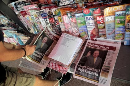 A man looks at the newspapers with news about Spain's former king Juan Carlos I, in Madrid, Spain August 4, 2020. REUTERS/Javier Barbancho