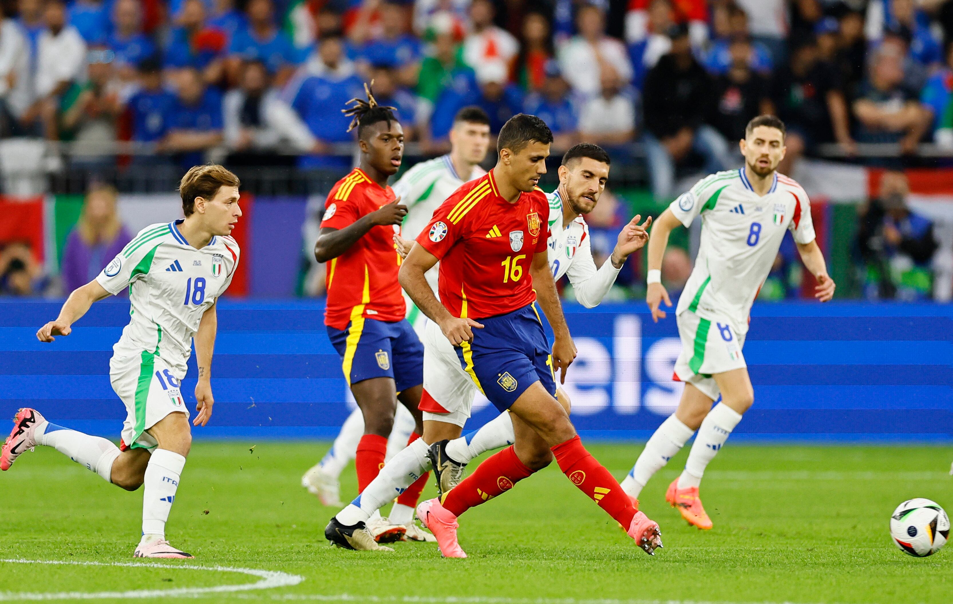 El español Rodri pasa la pelota mientras es perseguido por el italiano Nicolo Barella (REUTERS/Leon Kuegeler)