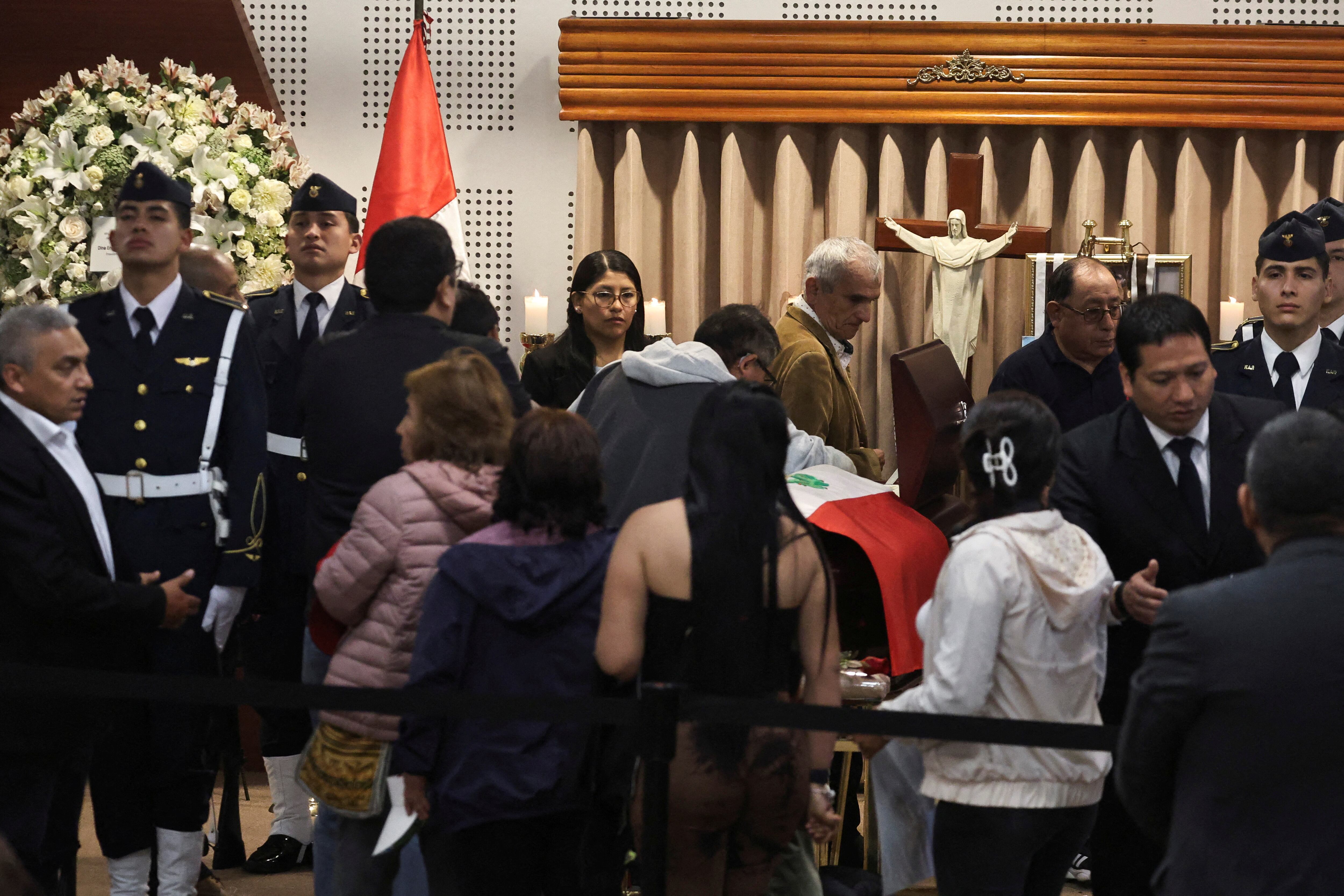 People queue up to pay their respects next to the coffin containing the body of Peru's former President Alberto Fujimori as it is exhibited for a posthumous tribute, at the Museo de la Nacion, in Lima, Peru, September 13, 2024. REUTERS/Sebastian Castaneda