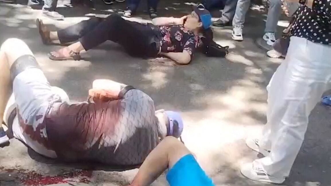 People gather around four American educators from an Iowa university, who were reportedly stabbed in a public park, according to the U.S. media and U.S. government officials, in Jilin City, Jilin province, China, in this still image taken from a video obtained by Reuters and released on June 10, 2024.  Video obtained by REUTERS  THIS IMAGE HAS BEEN SUPPLIED BY A THIRD PARTY. NO RESALES. NO ARCHIVES.