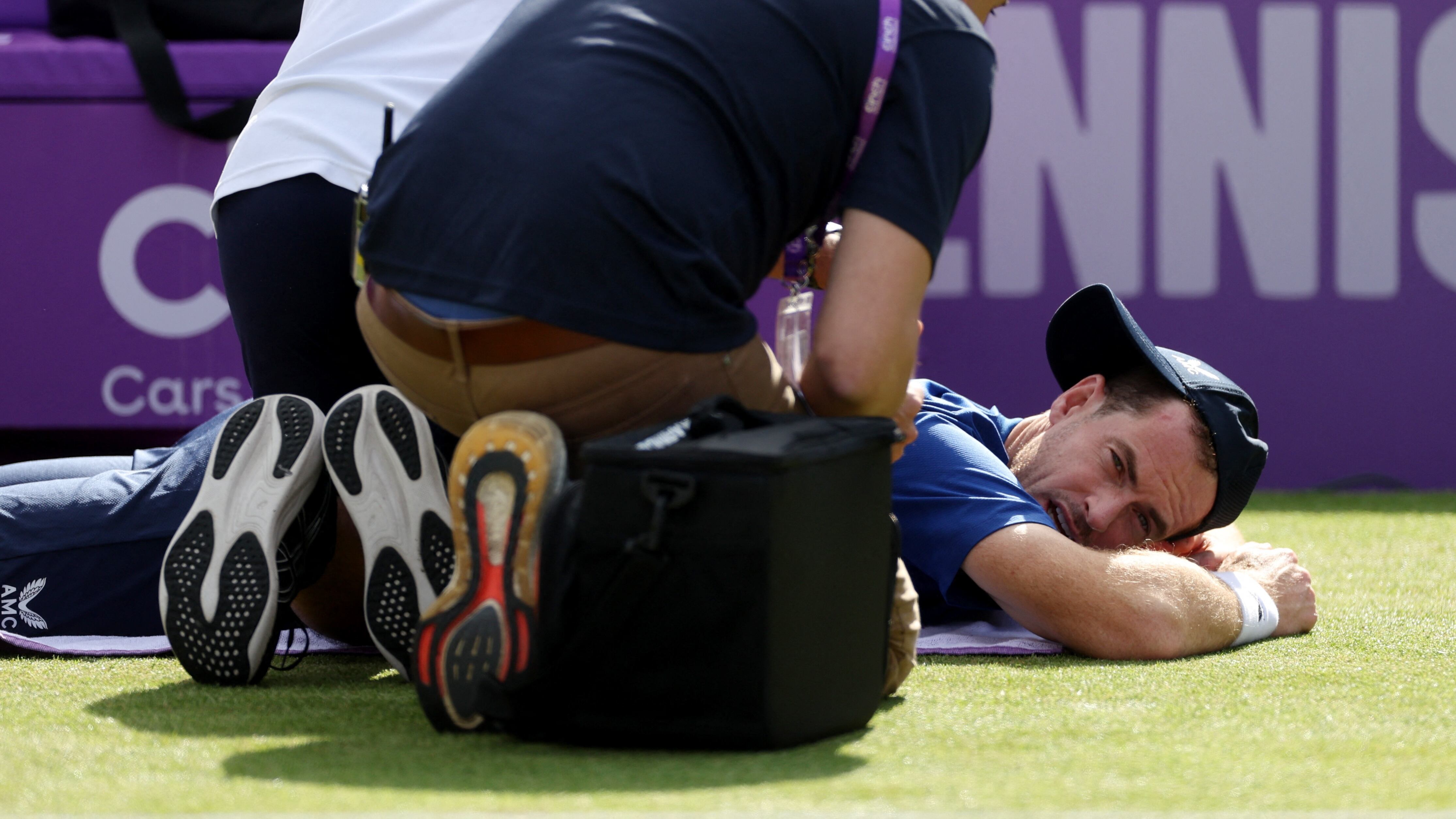 Tennis - Queen's Club Championships - The Queen's Club, London, Britain - June 19, 2024 Britain's Andy Murray receives treatment from the trainer during his men's singles second match against Australia's Jordan Thompson Action Images via Reuters/Paul Childs