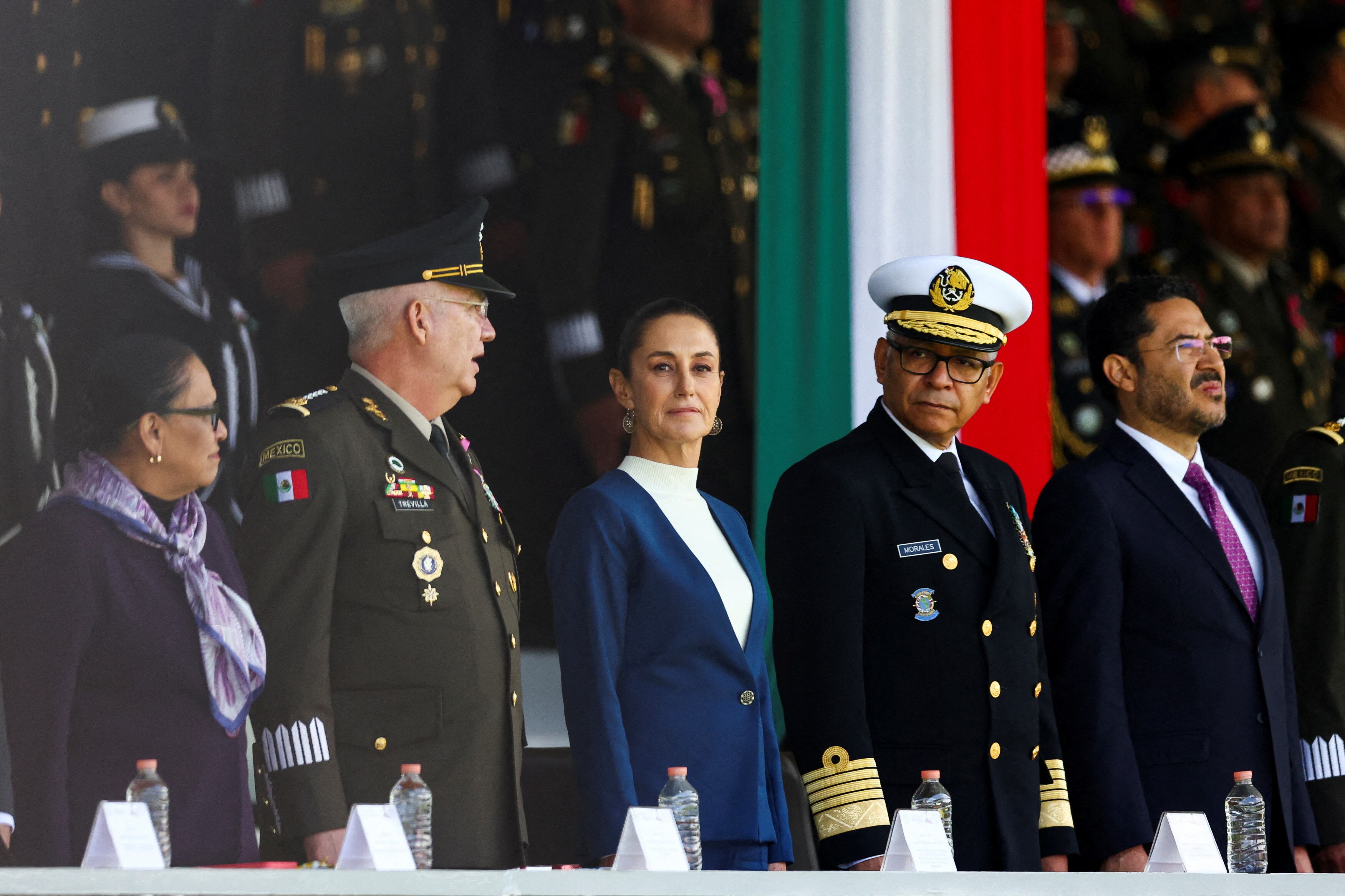 Mexico's Defense Minister Ricardo Trevilla Trejo and Secretary of the Navy Raymundo Pedro Morales Angeles stand next to Mexico's President Claudia Sheinbaum as Mexican Armed Forces salute President Sheinbaum as Commander-in-Chief during a ceremony at Military Camp 1, in Mexico City, Mexico October 3, 2024. REUTERS/Raquel Cunha     TPX IMAGES OF THE DAY