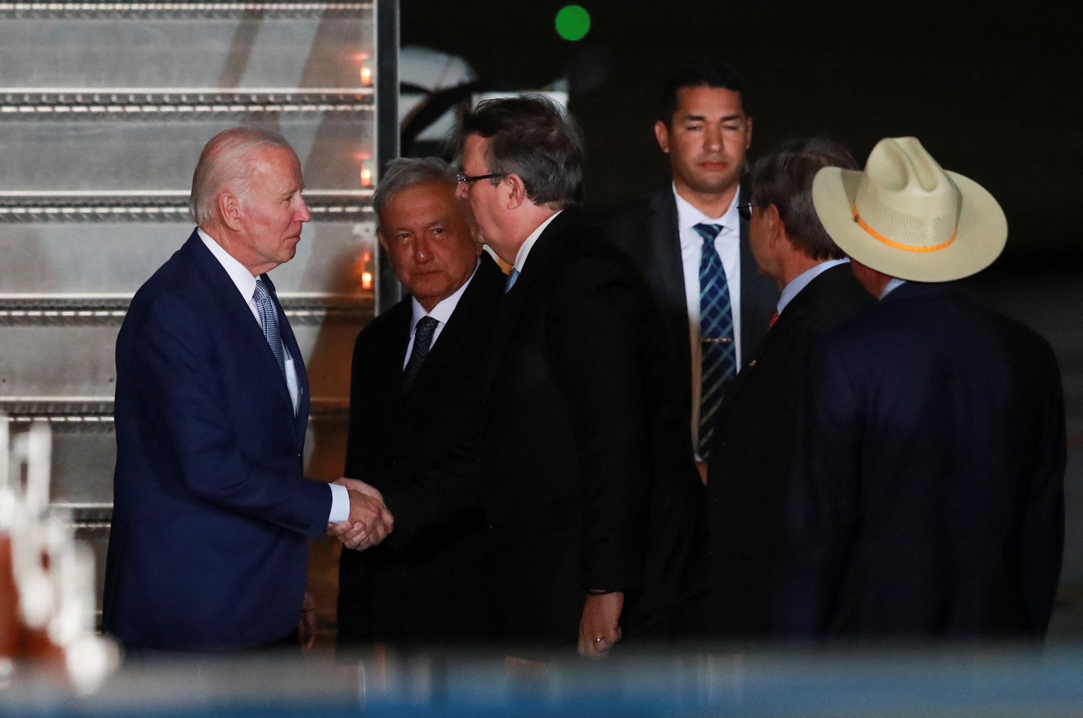 U.S. President Joe Biden is greeted by Mexico's Foreign Minister Marcelo Ebrard as he arrives at the Felipe Angeles International Airport, to attend the North American Leaders' Summit, in Santa Lucia, Mexico January 8, 2023.  REUTERS/Henry Romero