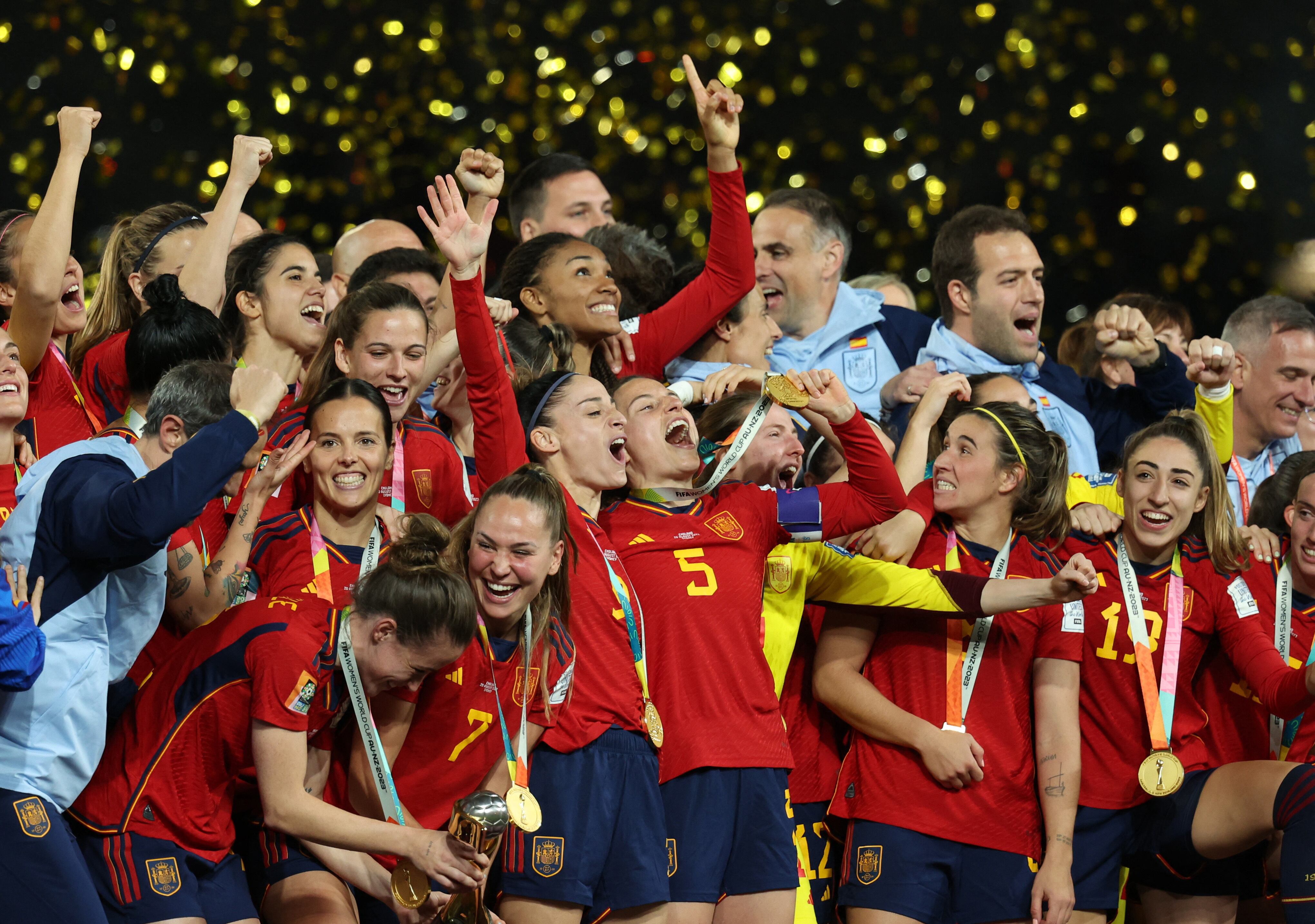 Soccer Football - FIFA Women's World Cup Australia and New Zealand 2023 - Final - Spain v England - Stadium Australia, Sydney, Australia - August 20, 2023 Spain's Ona Batlle and Irene Guerrero celebrate with the trophy and teammates after winning the World Cup final REUTERS/Asanka Brendon Ratnayake