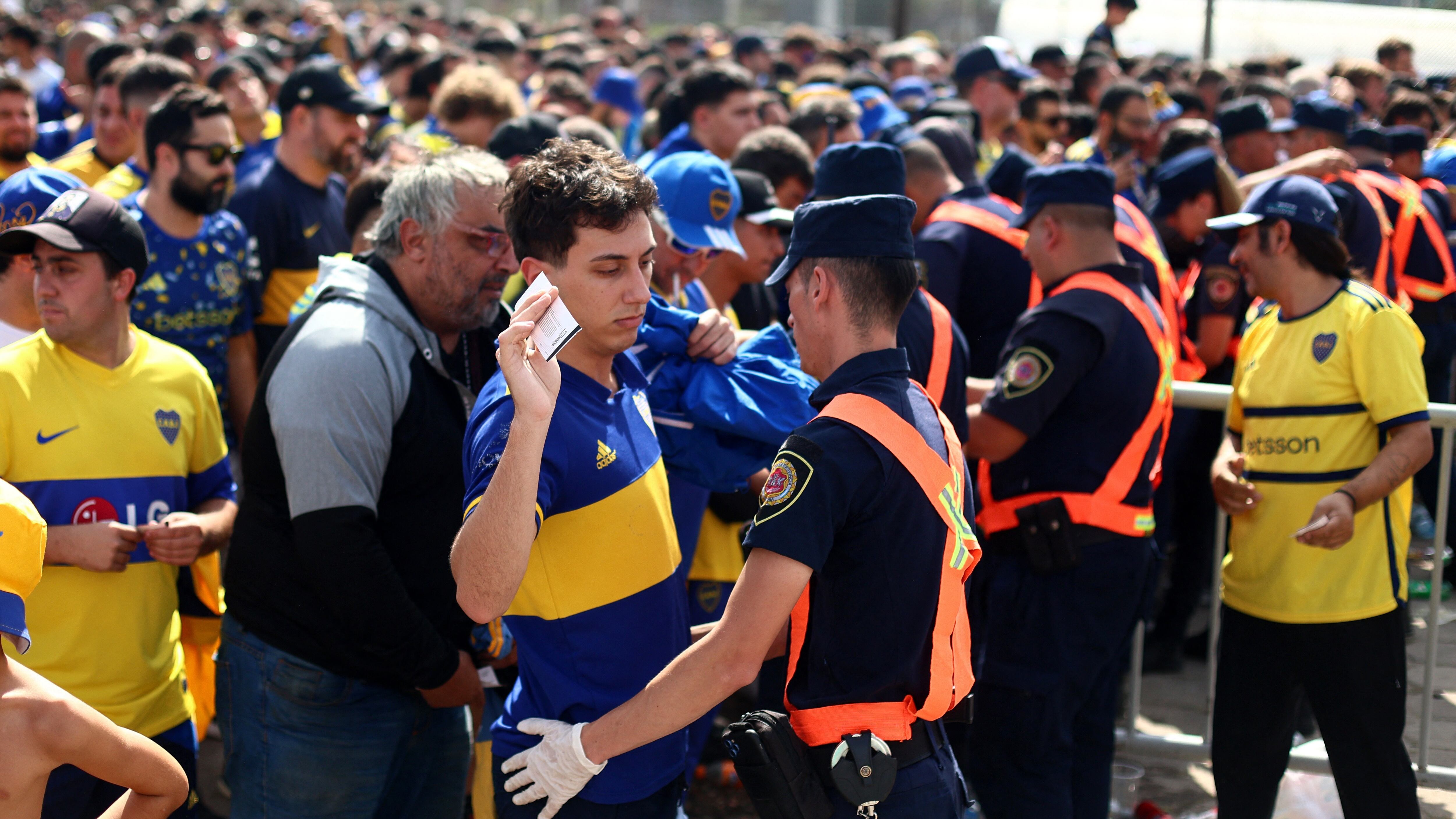 Soccer Football - Copa de la Liga - Quarter Final - Boca Juniors v River Plate - Estadio Mario Alberto Kempes, Cordoba, Argentina - April 21, 2024 Police officer search Boca Juniors fans outside the stadium before the match, as both sets of fans attend the match for the first time since 2018 REUTERS/Matias Baglietto