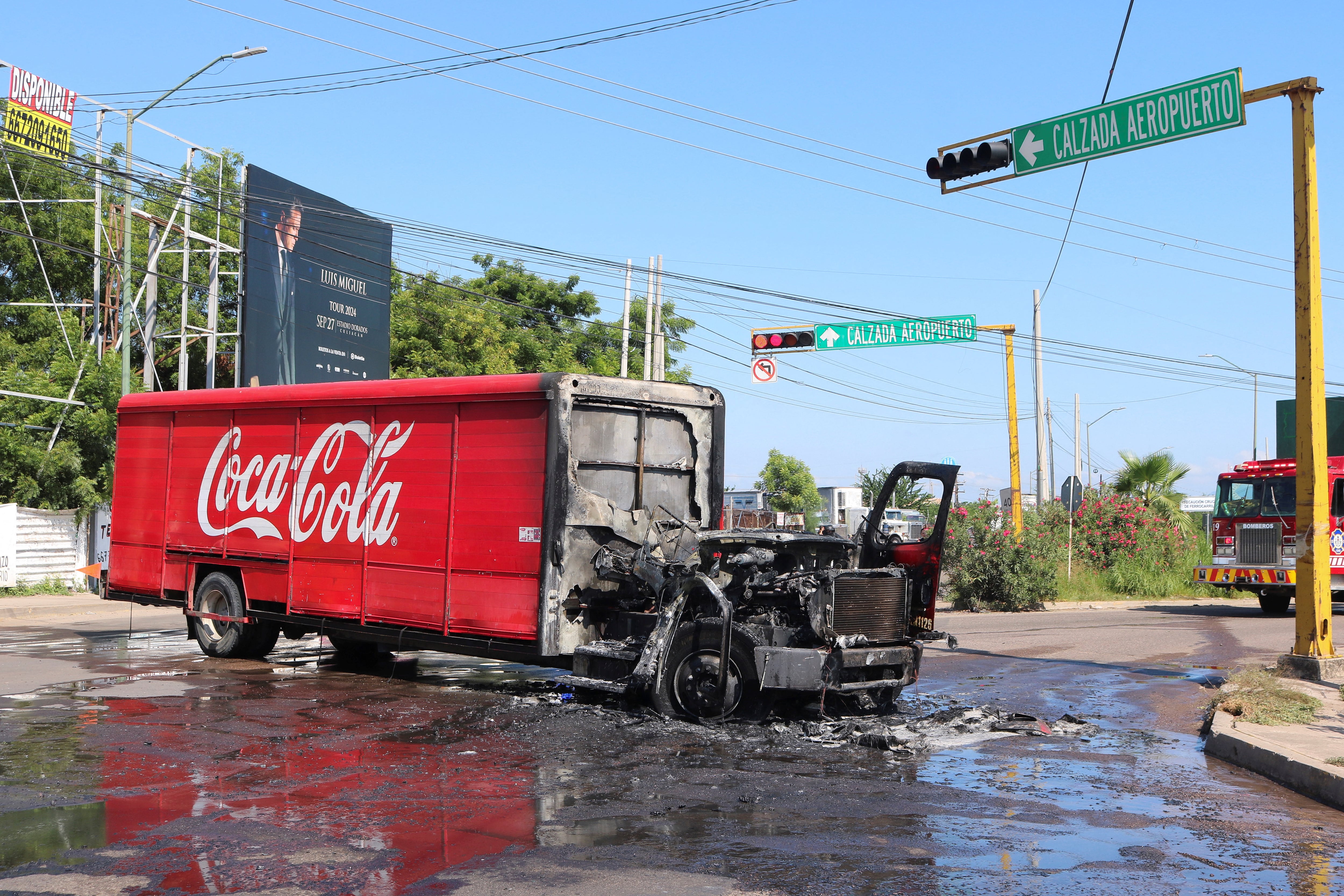 A burned delivery truck sits at an intersection amid a wave of violence between armed groups, in Culiacan, Mexico, September 11, 2024. REUTERS/Jesus Bustamante