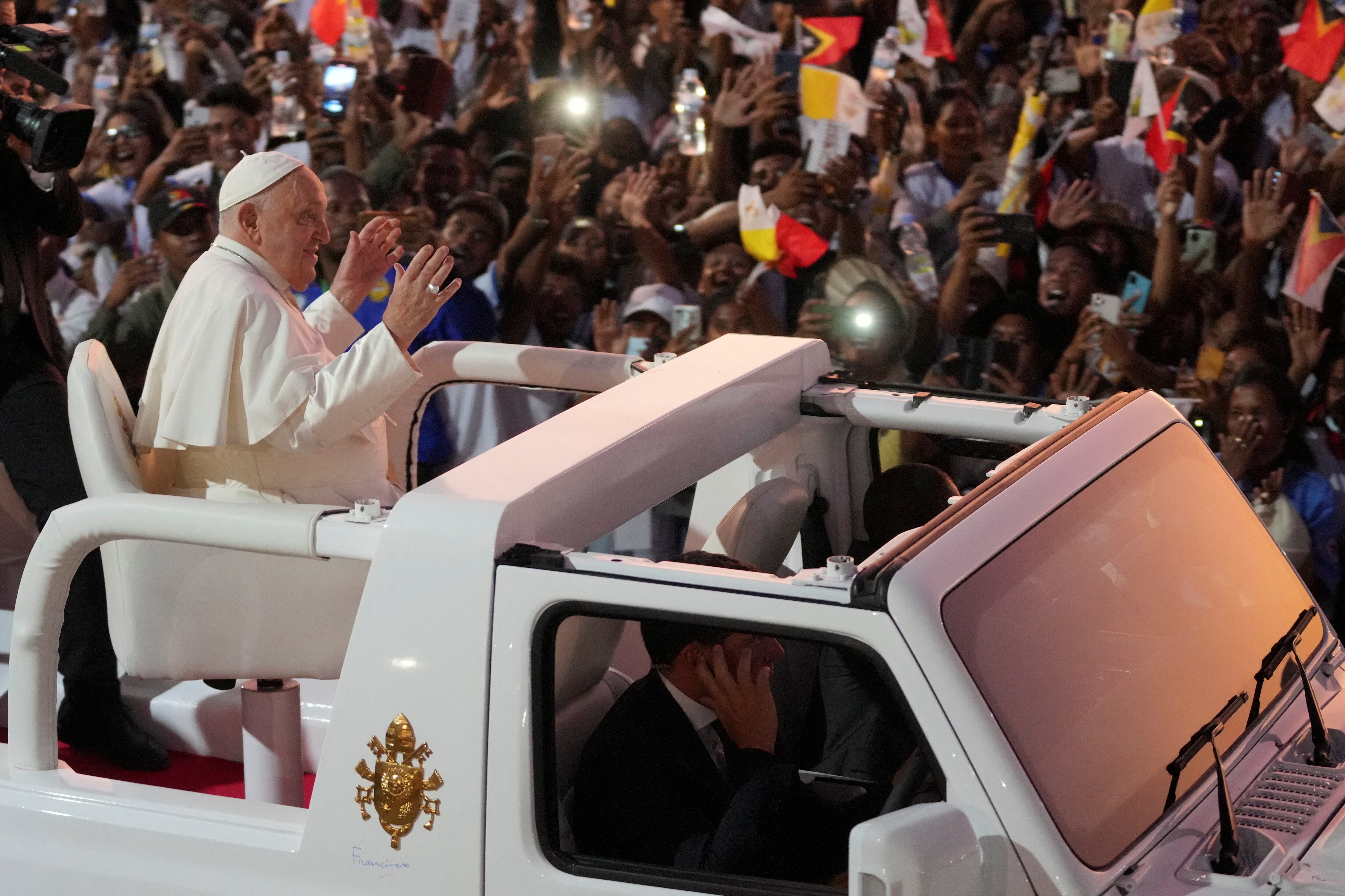 El Papa Francisco gesticula a su salida tras dirigir una santa misa en el parque Tasitolu de Dili.