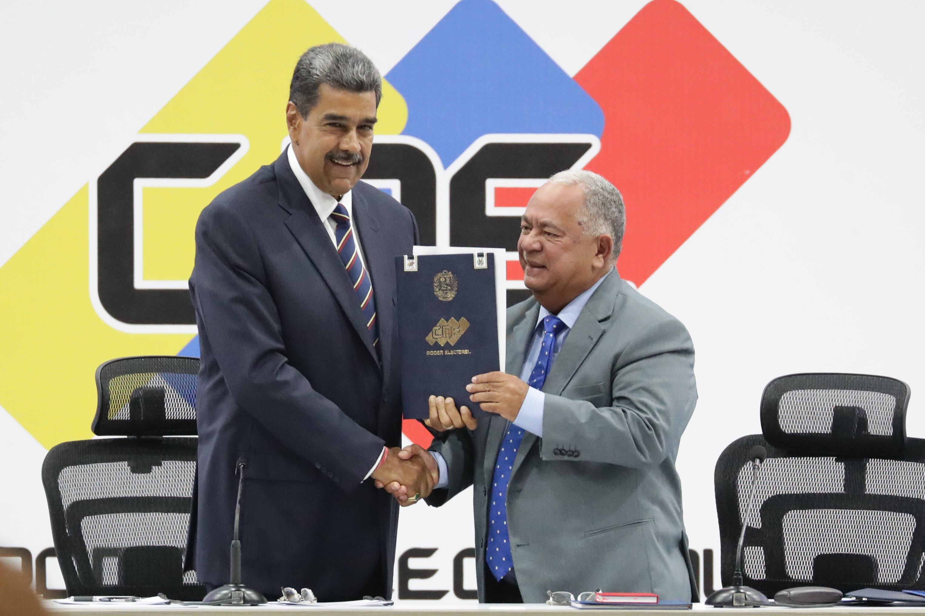 El presidente de Venezuela, Nicolás Maduro, y el presidente de Consejo Nacional Electoral (CNE), Elvis Amoroso, sostienen el acta de juramentación del presidente electo  