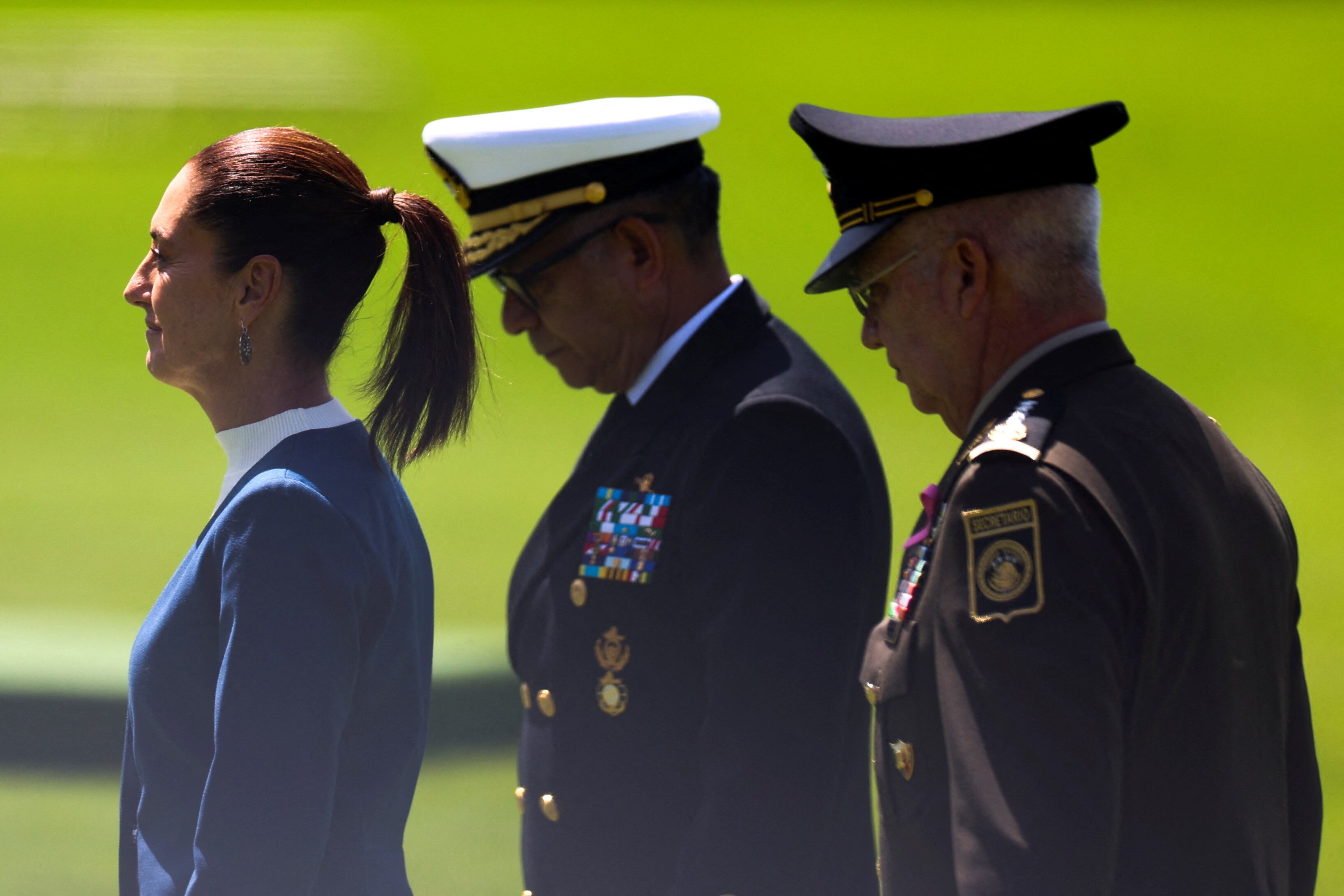 El titular de la Defensa de Nacional, Ricardo Trevilla Trejo, y el secretario de Marina, Raymundo Pedro Morales Ángeles, caminan junto a la Presidenta de México, Claudia Sheinbaum, mientras las Fuerzas Armadas mexicanas saludan al Presidente Sheinbaum como Comandante en Jefe durante una ceremonia en el Campamento Militar 1, en la Ciudad de México, México, el 3 de octubre. , 2024. REUTERS/Raquel Cunha