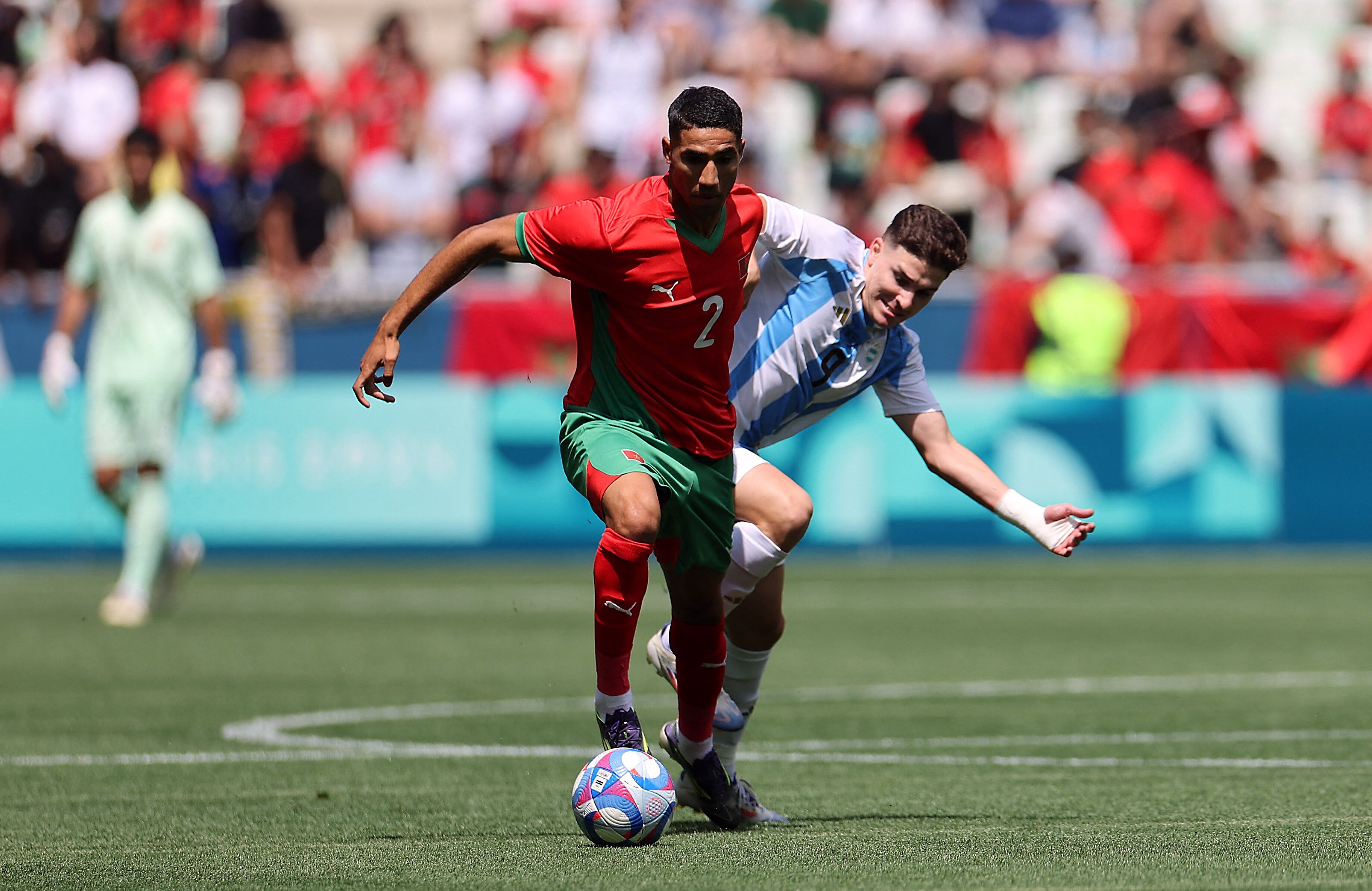 Julián Álvarez pelea ante Achraf Hakimi en el debut por los Juegos Olímpicos (REUTERS/Thaier Al-Sudani)