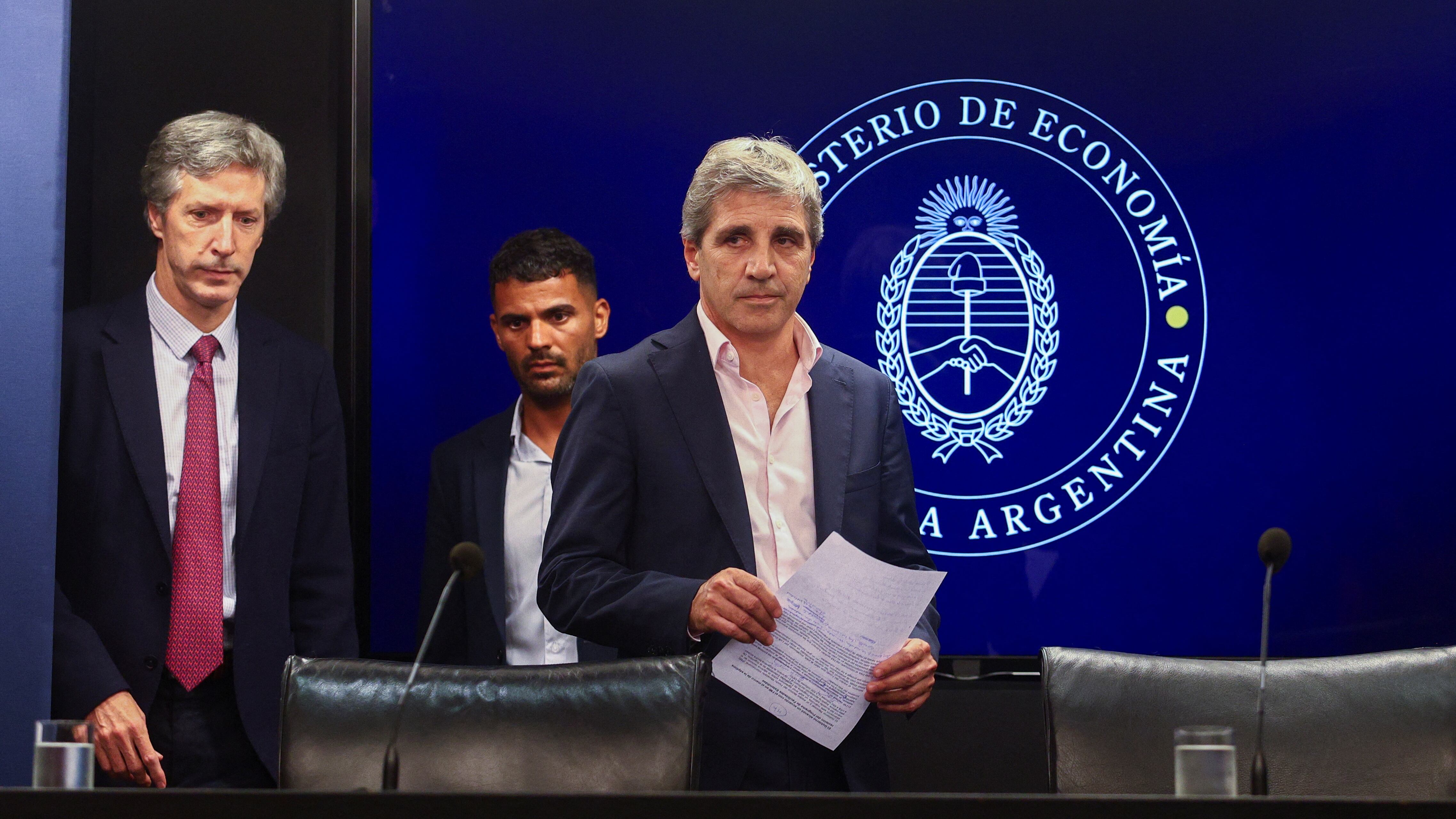 Argentina's Economy Minister Luis Caputo and Central Bank's President Santiago Bausili arrive for a press conference following a staff-level agreement with the International Monetary Fund (IMF) on the latest review of the country's $44 billion debt program, at the Economy Ministry building in Buenos Aires, Argentina, January 10, 2024. REUTERS/Matias Baglietto