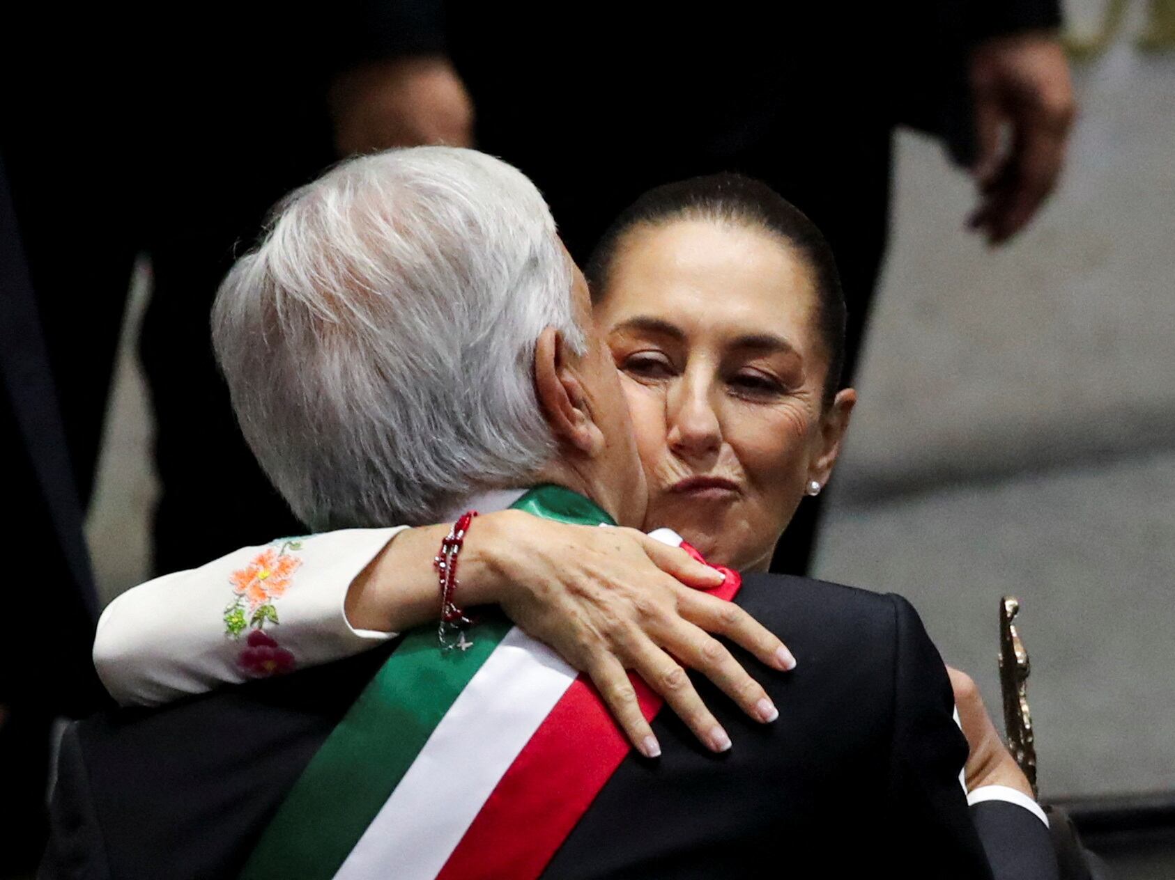 Mexico's President Andres Manuel Lopez Obrador and President-elect Claudia Sheinbaum embrace on the day of her swearing-in ceremony as new Mexican President at the Congress, in Mexico City, Mexico, October 1, 2024. REUTERS/Henry Romero