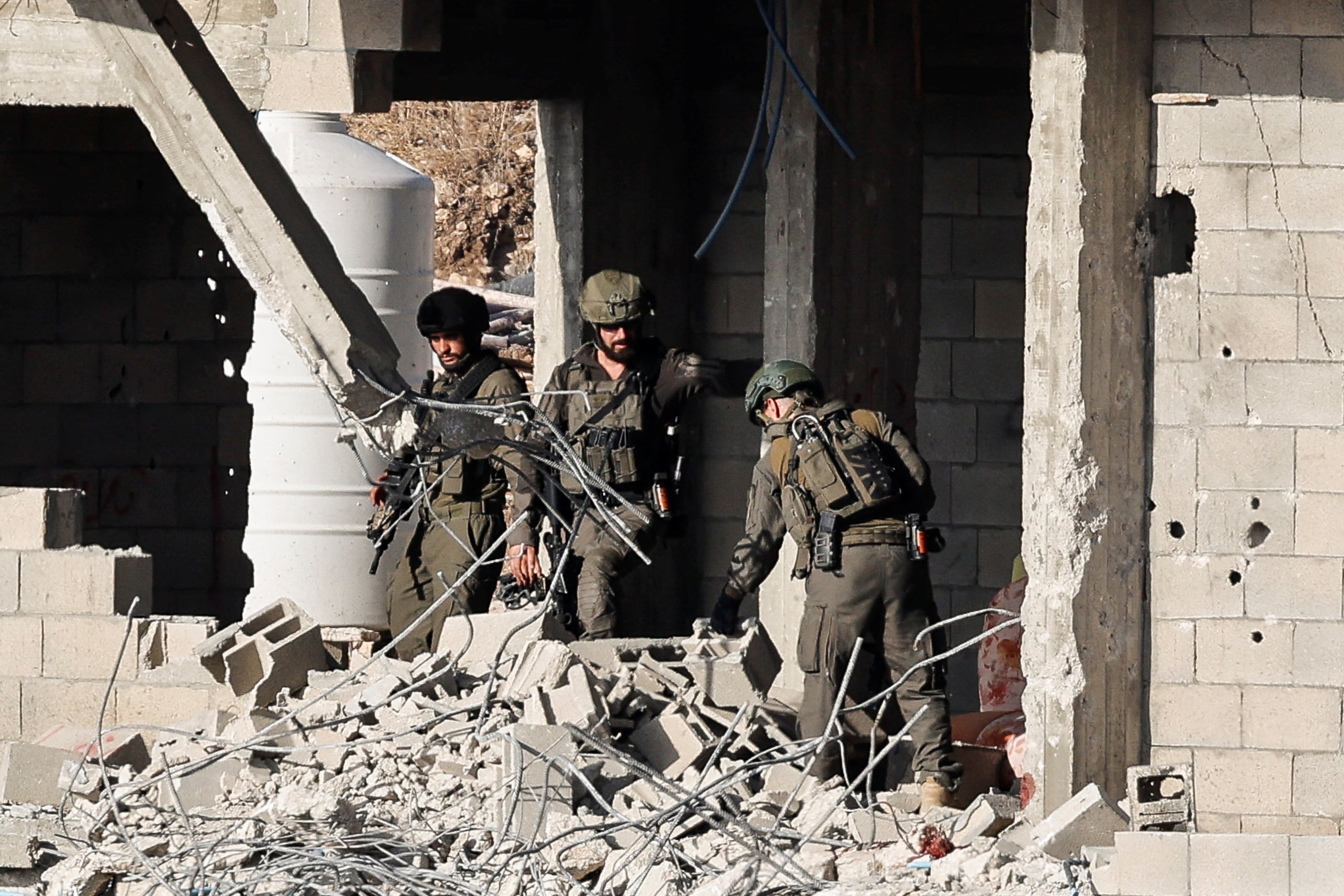 Israeli soldiers look on, during a military operation, in Qabatiya, near Jenin, in the Israeli-occupied West Bank, June 13, 2024. REUTERS/Raneen Sawafta