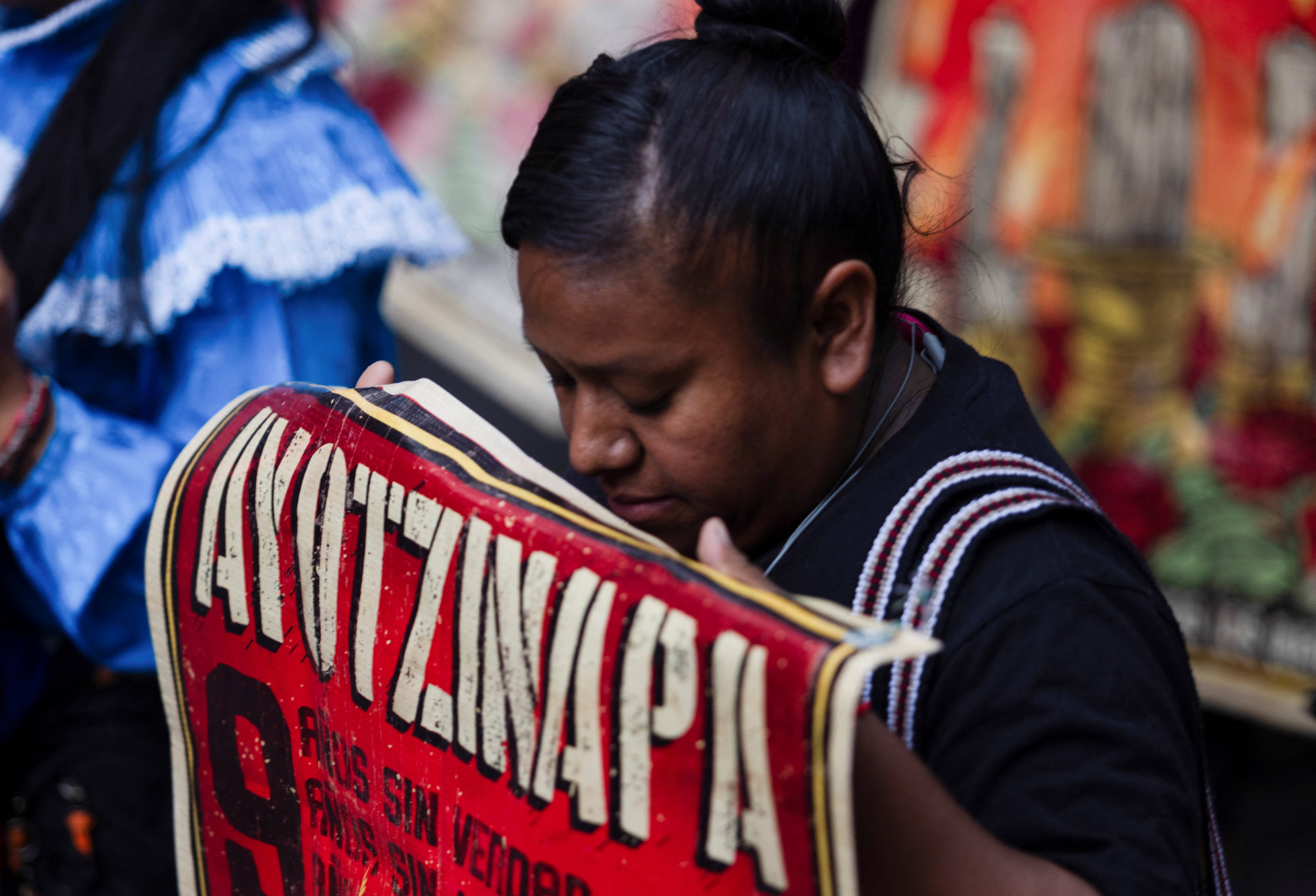 A student of Ayotzinapa holds a banner during a march to demand justice for the missing students from Ayotzinapa Teacher Training College, in Mexico City, Mexico, May 26, 2024. REUTERS/Quetzalli Nicte-Ha