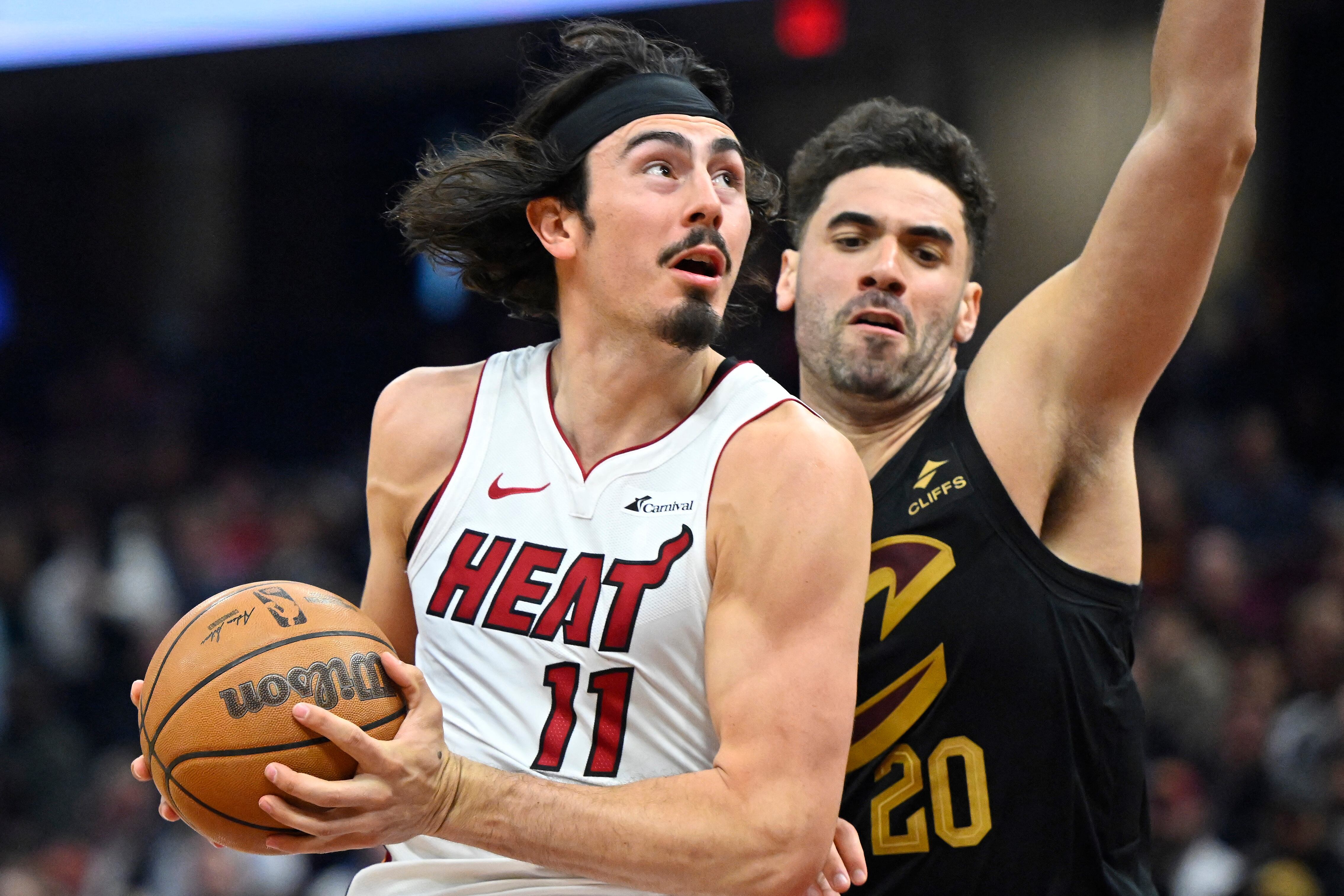 Mar 20, 2024; Cleveland, Ohio, USA; Miami Heat guard Jaime Jaquez Jr. (11) drives against Cleveland Cavaliers forward Georges Niang (20) in the second quarter at Rocket Mortgage FieldHouse. Mandatory Credit: David Richard-USA TODAY Sports