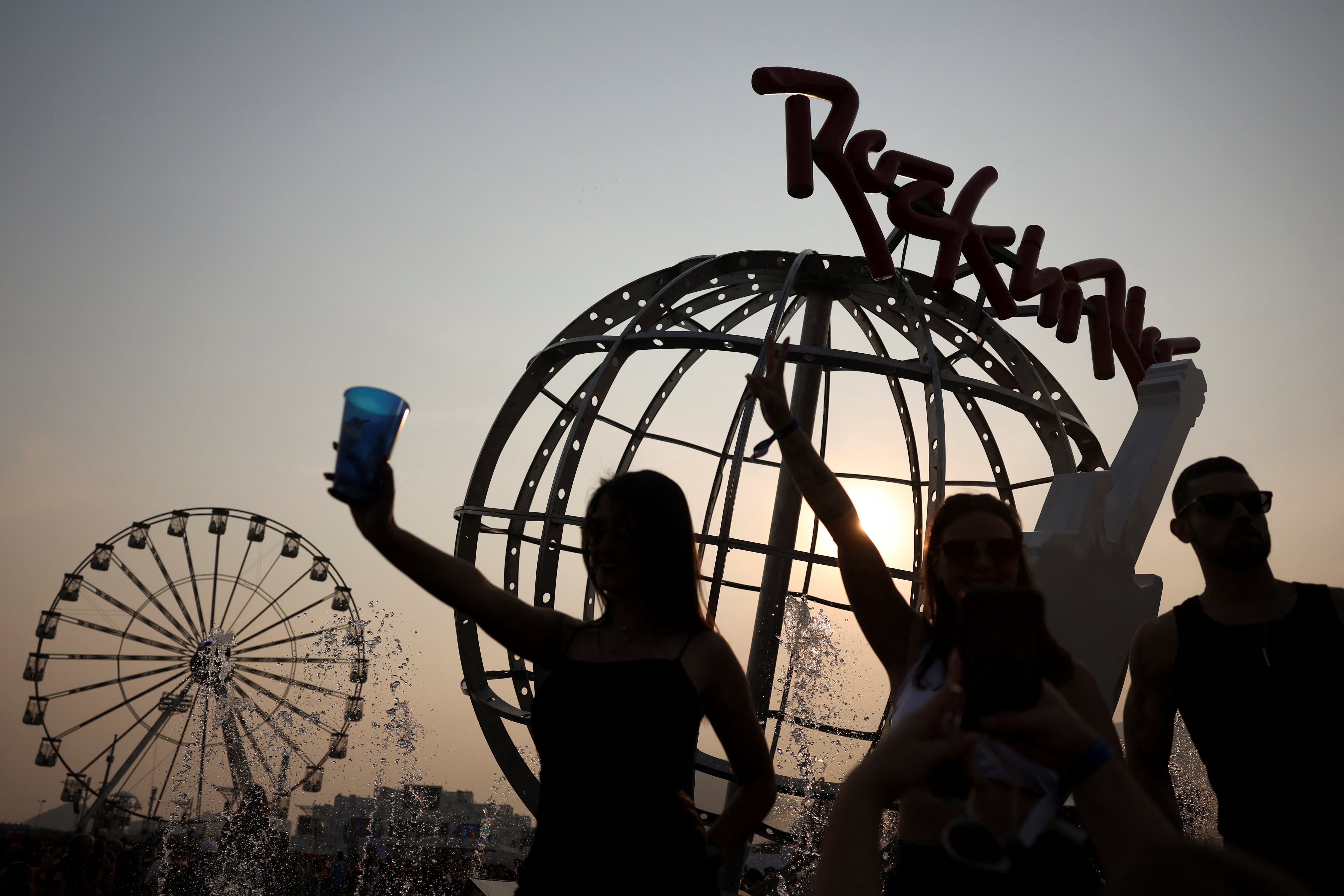 People pose for a picture during the Rock in Rio music festival in Rio de Janeiro, Brazil, September 14, 2024. REUTERS/Pilar Olivares