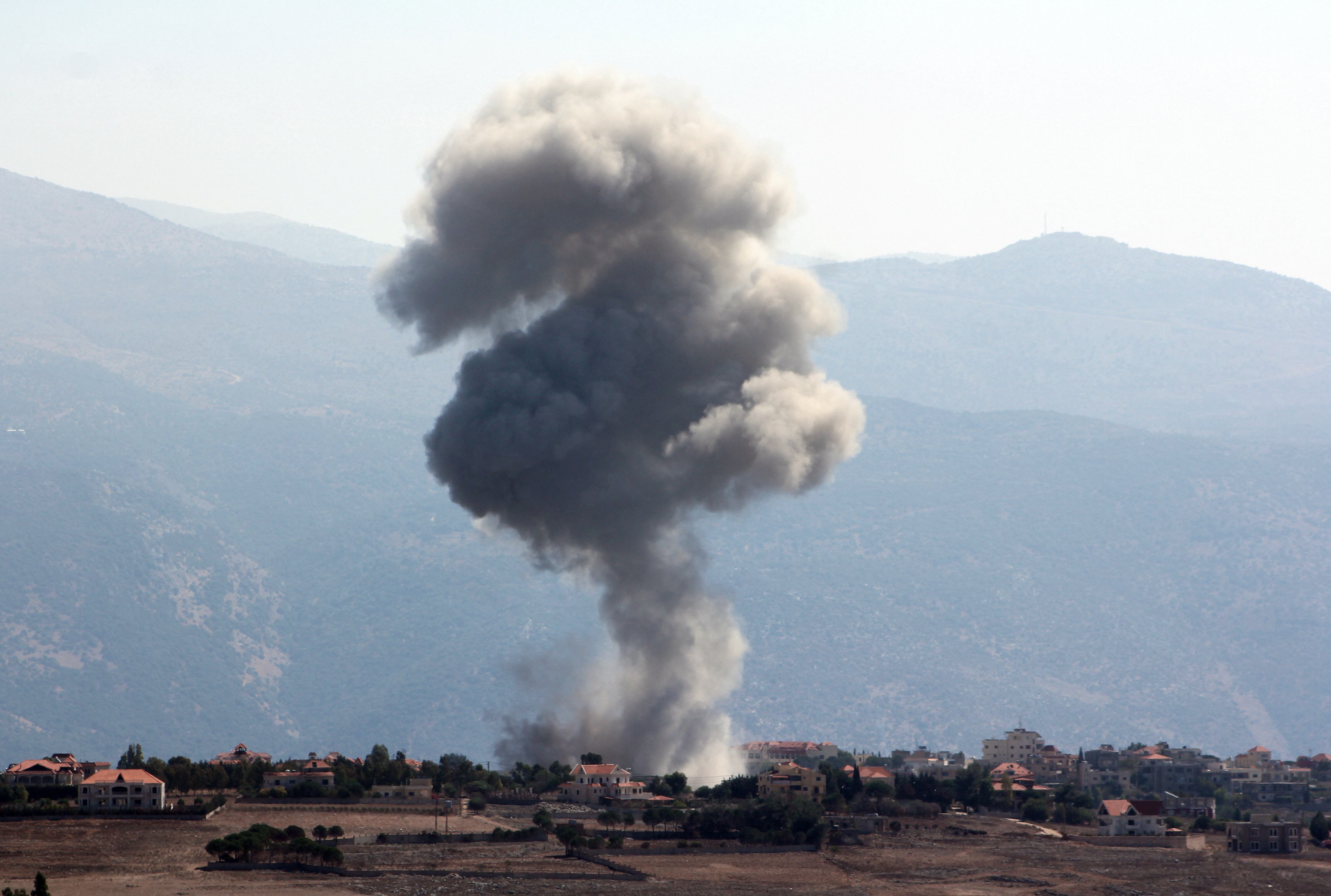 Smoke billows over Khiam, amid ongoing cross-border hostilities between Hezbollah and Israeli forces, as pictured from Marjayoun, near the Lebanese border with Israel, September 30, 2024. REUTERS/Karamallah Daher