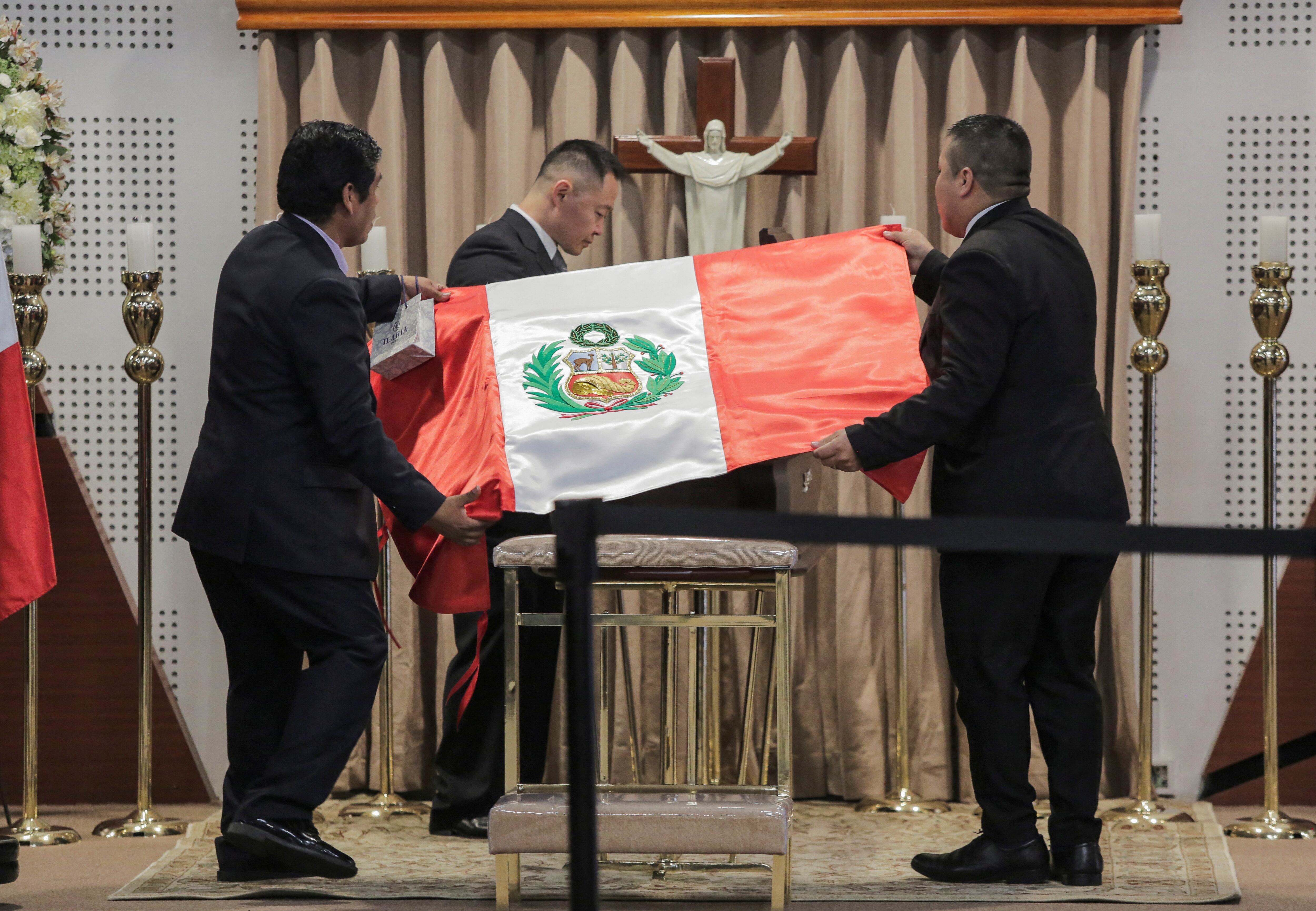 Kenji Fujimori pays his respects at the coffin containing the body of his father, Peru's former President Alberto Fujimori, as it is exhibited for a posthumous tribute, at the Museo de la Nacion, in Lima, Peru, September 12, 2024. REUTERS/Gerardo Marin