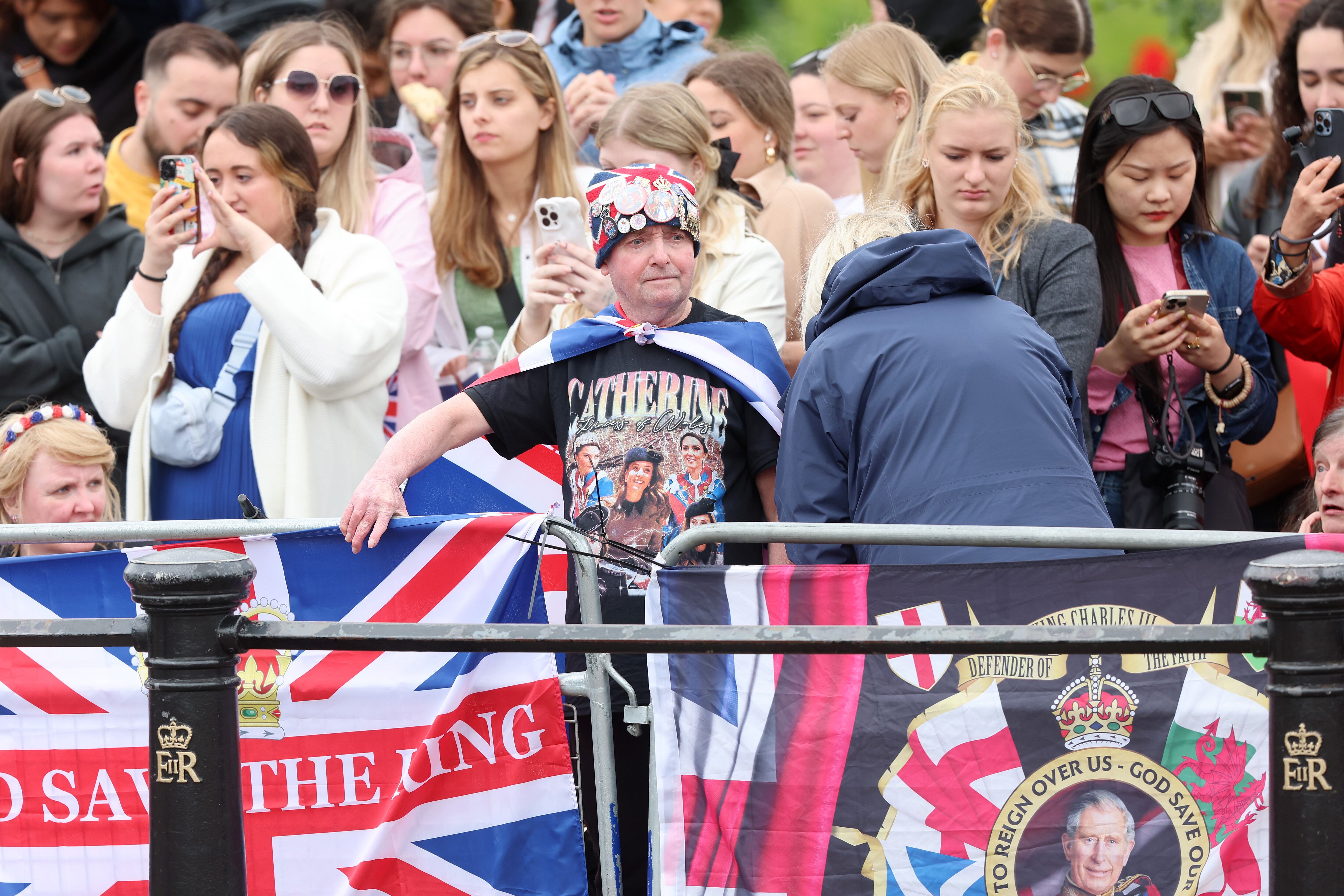 LONDON, ENGLAND - JUNE 15: Members of the public ahead of Trooping the Colour at Buckingham Palace on June 15, 2024 in London, England. Trooping the Colour is a ceremonial parade celebrating the official birthday of the British Monarch. The event features over 1,400 soldiers and officers, accompanied by 200 horses. More than 400 musicians from ten different bands and Corps of Drums march and perform in perfect harmony. (Photo by Chris Jackson/Getty Images)