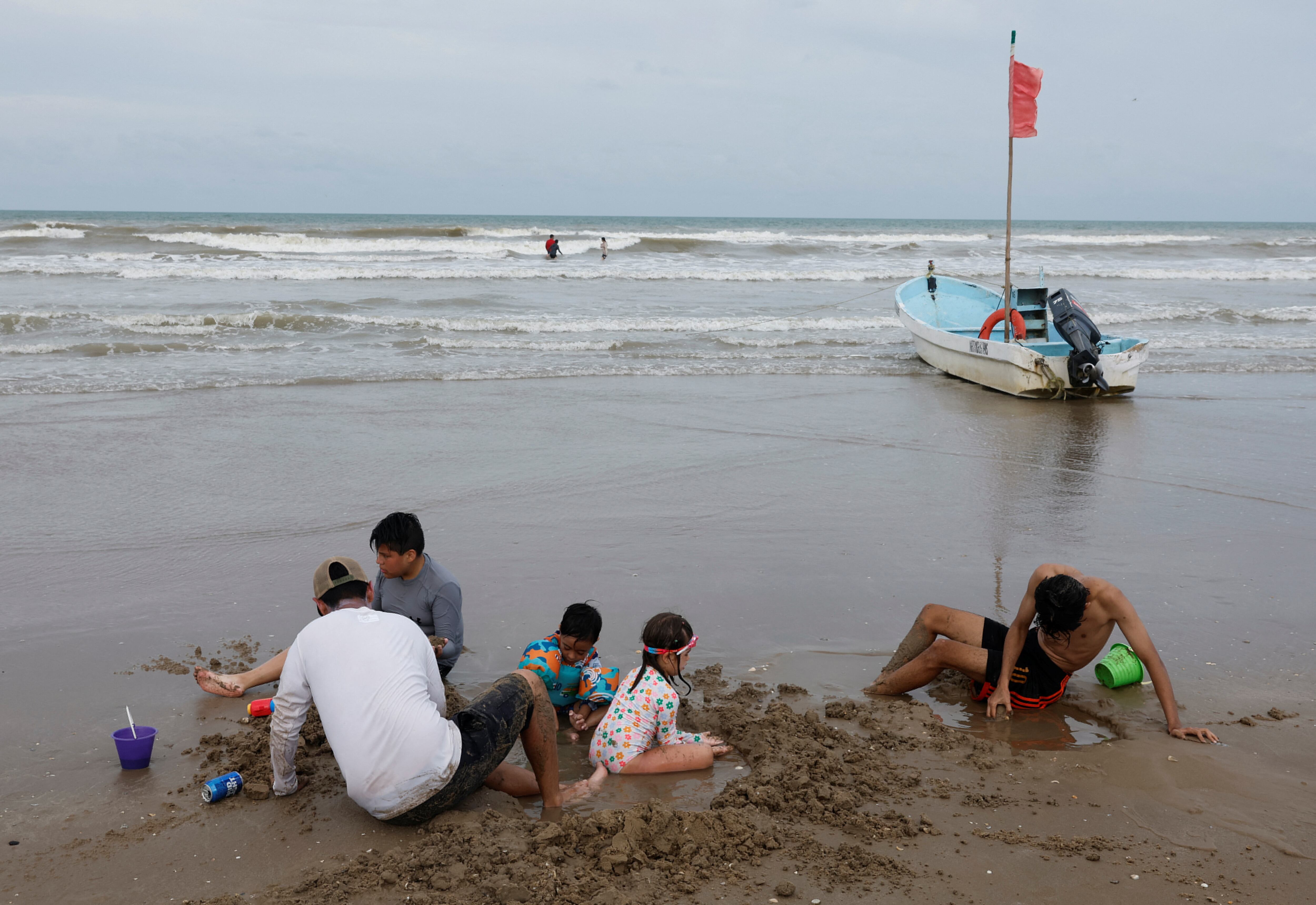 People enjoy the beach as tropical storm Beryl continues to move through the Gulf of Mexico, in Playa Bagdad, Mexico July 6, 2024. REUTERS/Daniel Becerril