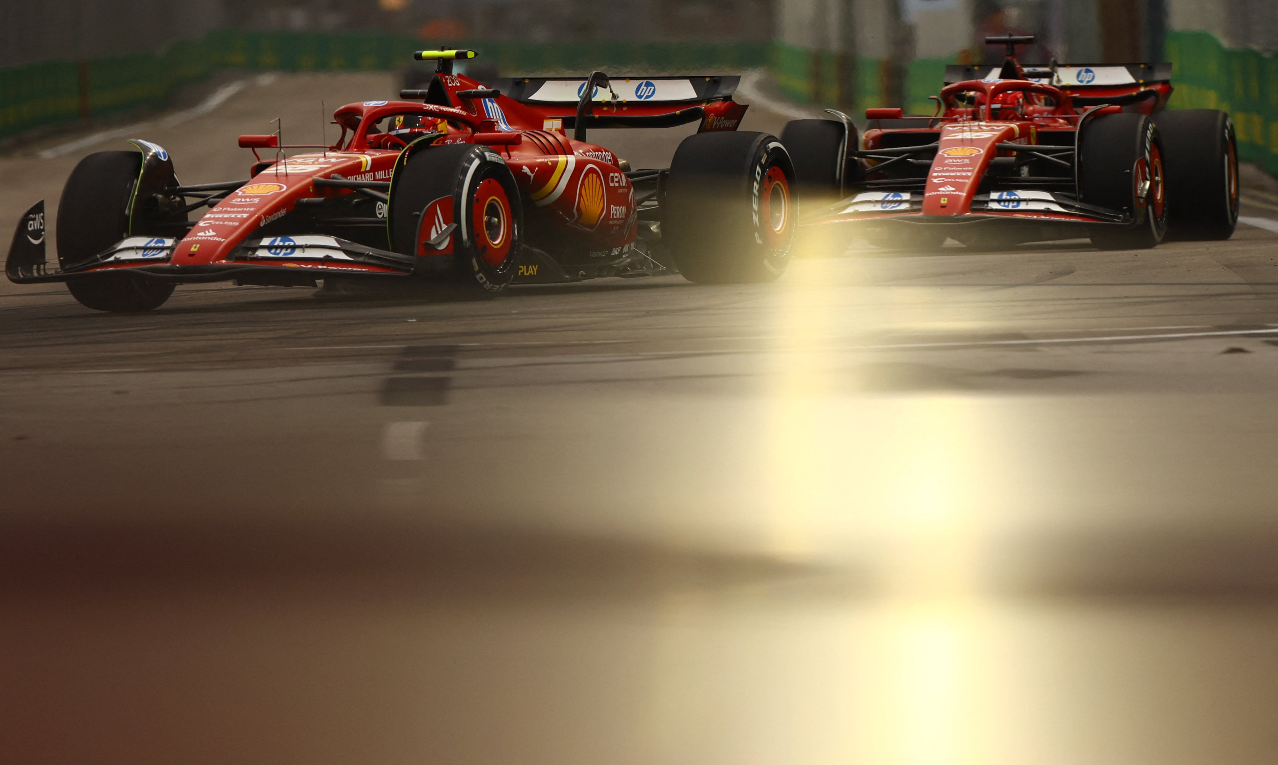 Formula One F1 - Singapore Grand Prix - Marina Bay Street Circuit, Singapore - September 20, 2024 Ferrari's Carlos Sainz Jr. and Ferrari's Charles Leclerc during practice REUTERS/Edgar Su